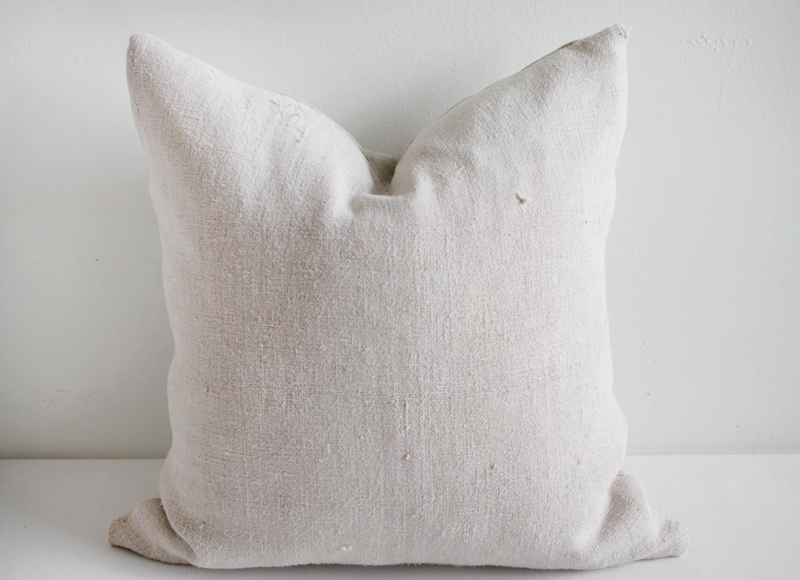 Vintage European grain sack hemp pillow with pale pink stripes
Pillow face, vintage textile with thick nubby texture, oatmeal color, with pale muted pink stripe, barely visible. The backing is 100% Irish linen in natural linen. Our pillows are