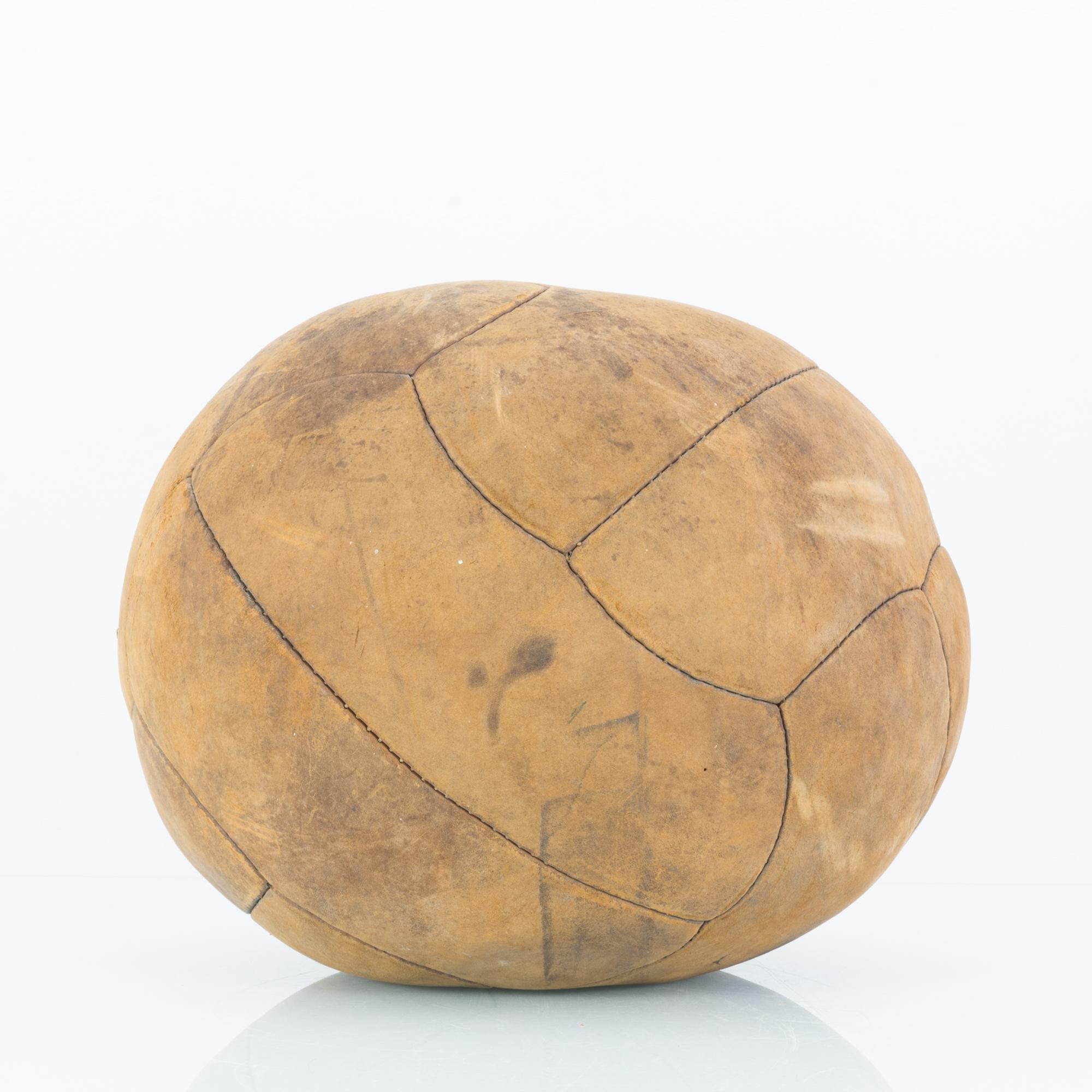 This medicine ball was made in Central Europe. Handcrafted from leather panels, this medicine ball sports a timeworn patina with a camel tone, seasoned from the past rigors of a fitness regime.