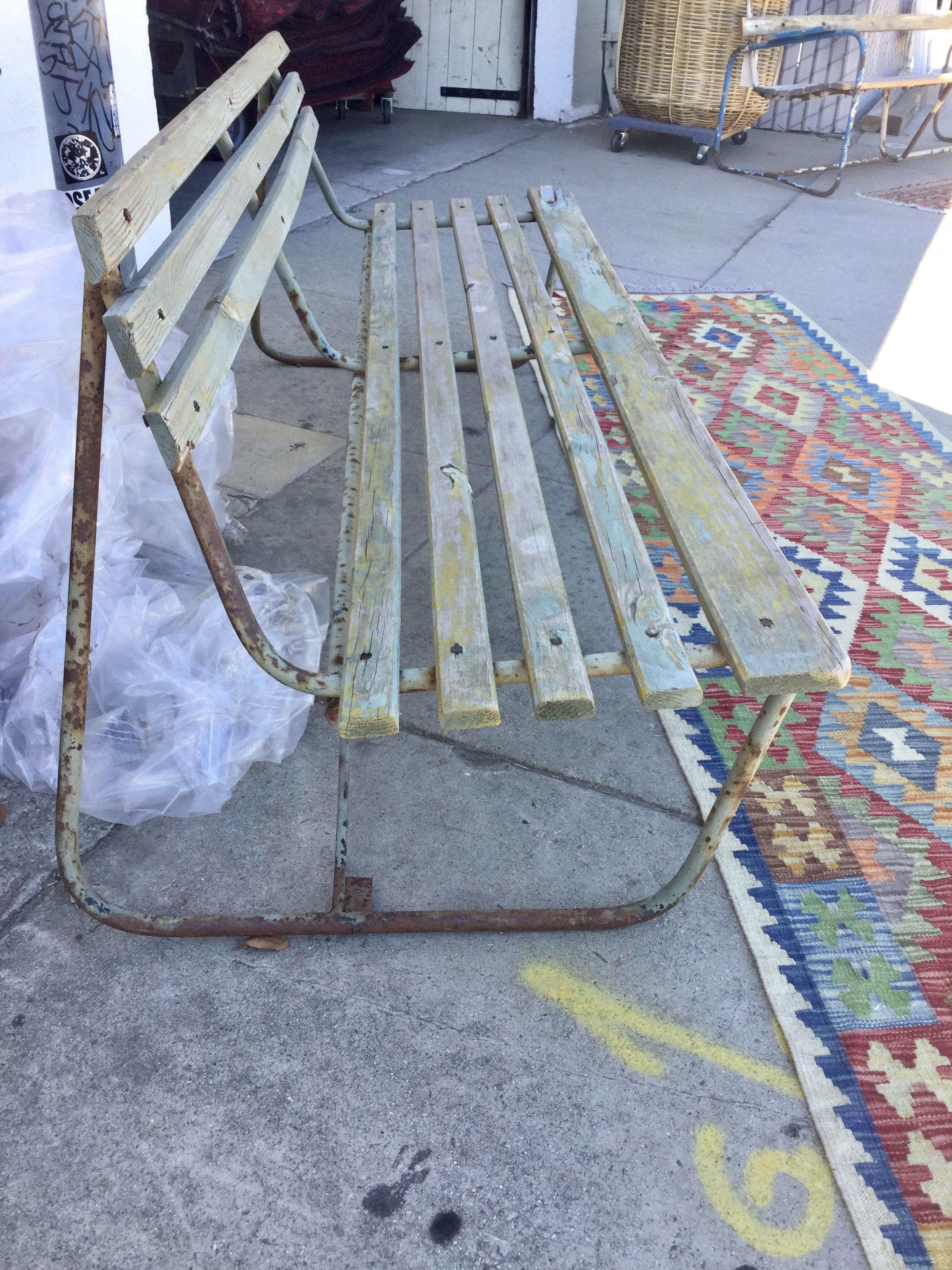 This bench has all the vintage charm. Its lovingly worn-in mint green paint has chipped in areas, and the metal has rust spots throughout. All imperfections shown.