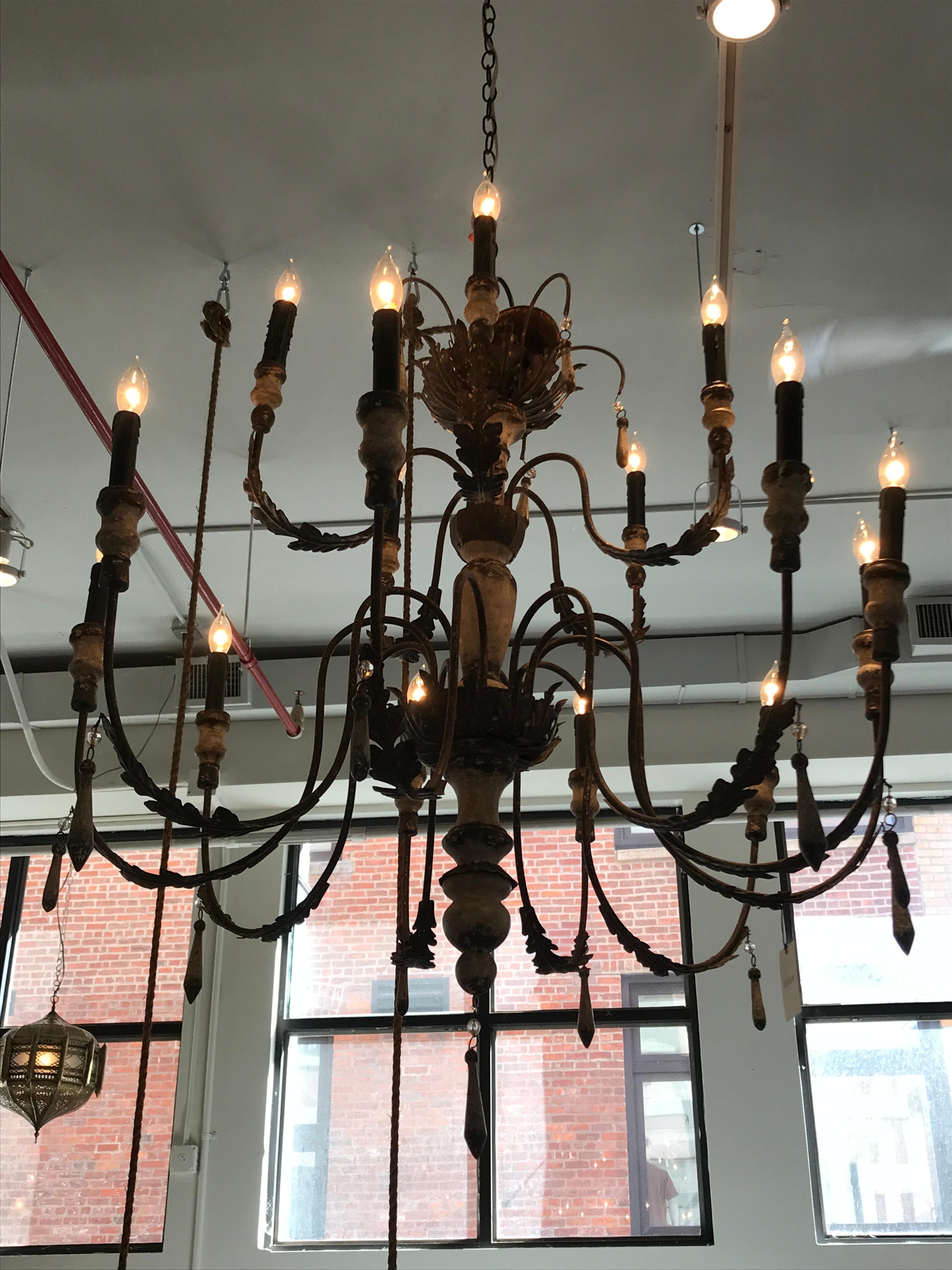 A timeless vintage European chandelier with an exquisite patina that wraps the bronze arms. The contrasting color of patina and aged bronze will enrich any home with historic charm.