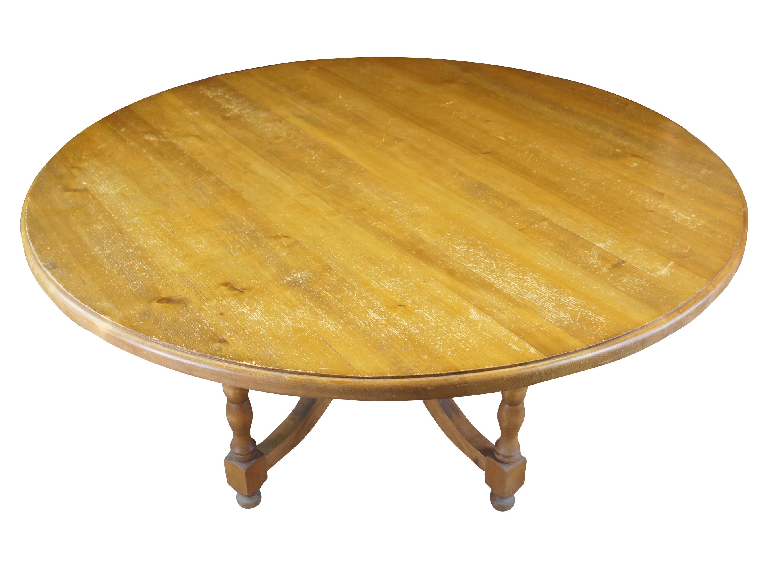 A large impressive European dining, breakfast or center table. Made from distressed pine in the Czech Republic, circa 1980s. Features a large round top over a five leg baluster turned base with bun feet. Each leg is connected to the robust center