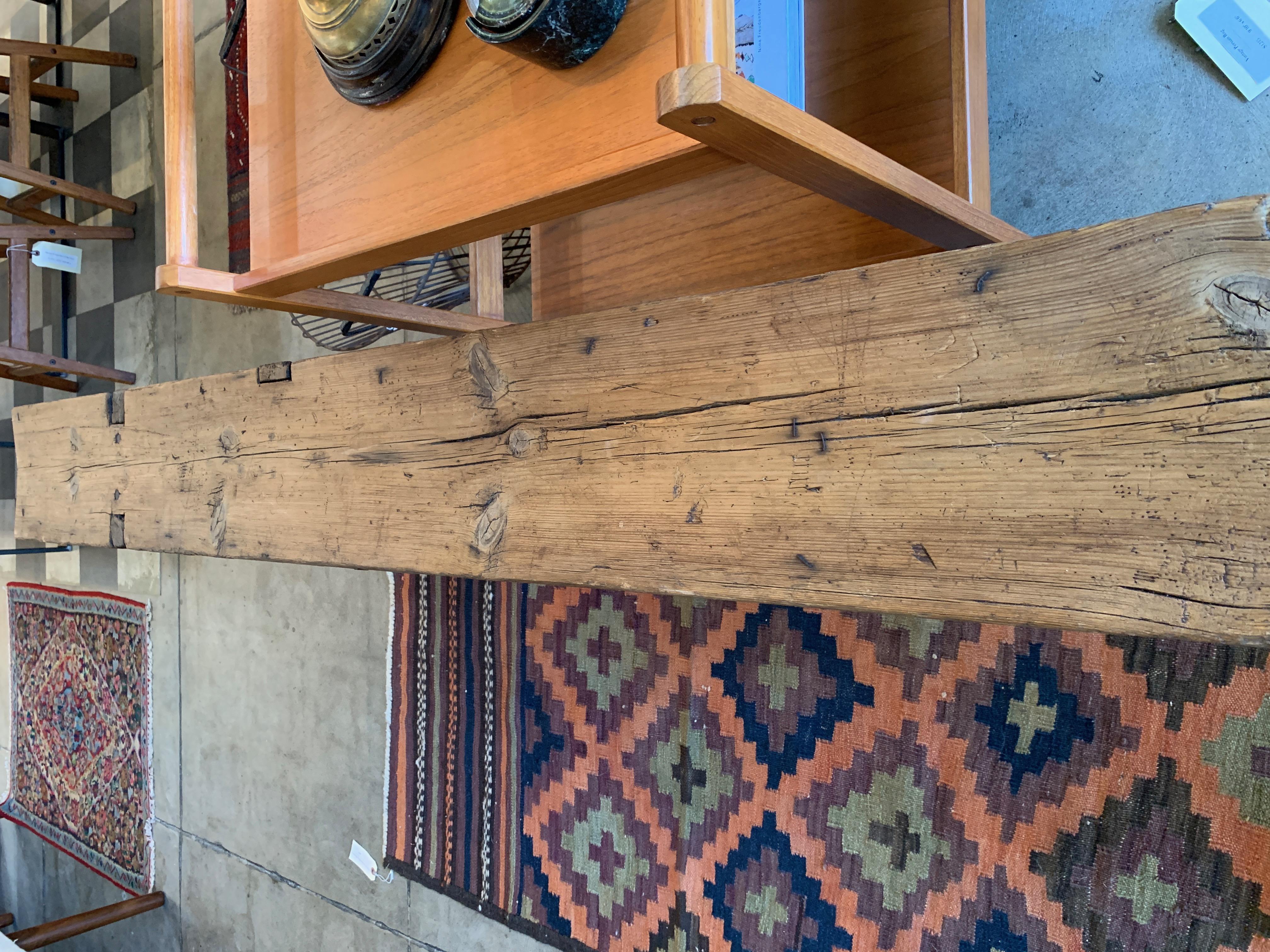 A Classic rustic farm bench with arrowed block legs, angular supports and wood aged perfectly with lots of character. This long bench is great for an entryway, garden or as seating with a dining table.