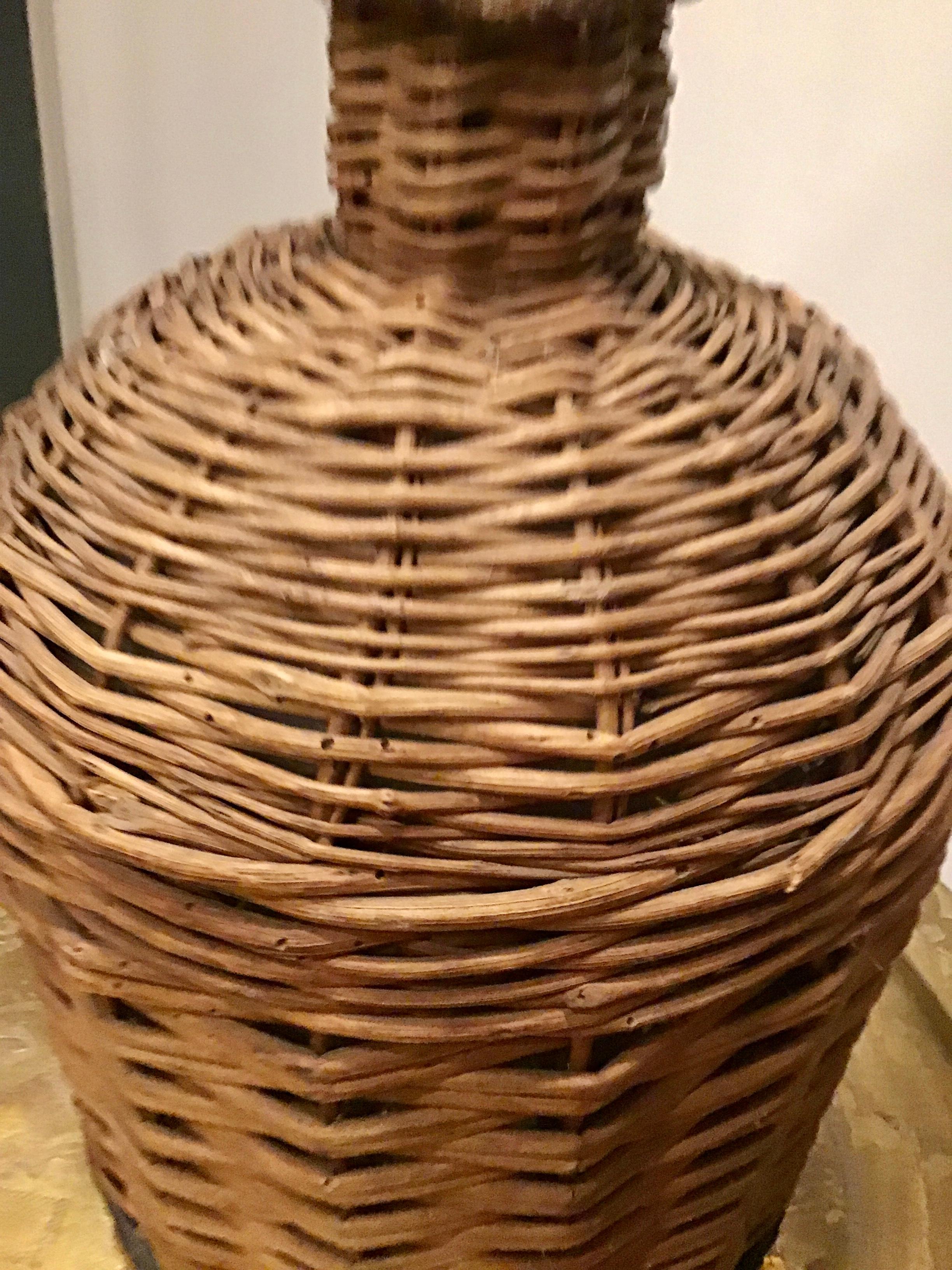 Decorative vintage European jug wrapped in wicker. This jug was once used to age wine.