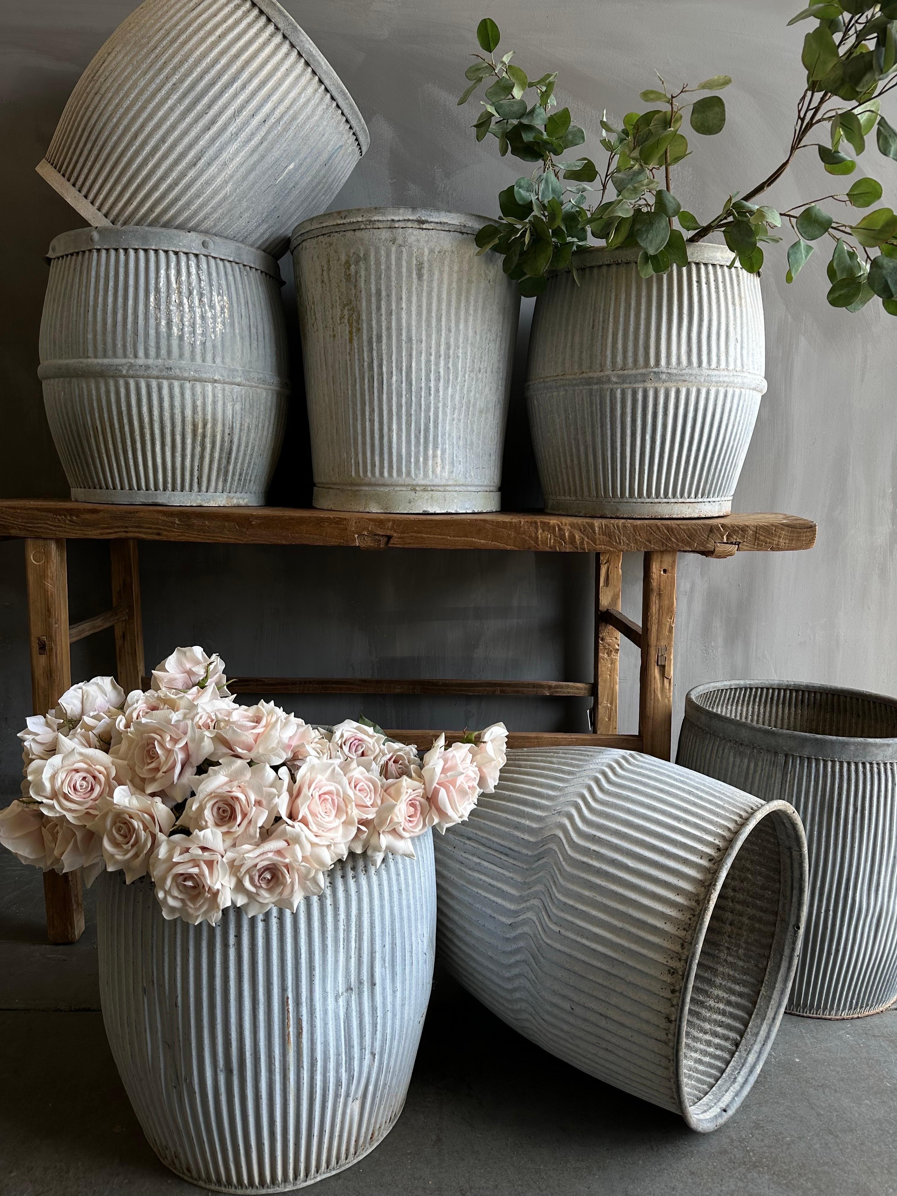 These European zinc barrels were once used in early 20th century England as a laundry alternative to the washboard, these antique, galvanized barrel with aged patina can be used for storage, planters, vessels for firewood, or easy organizers in the