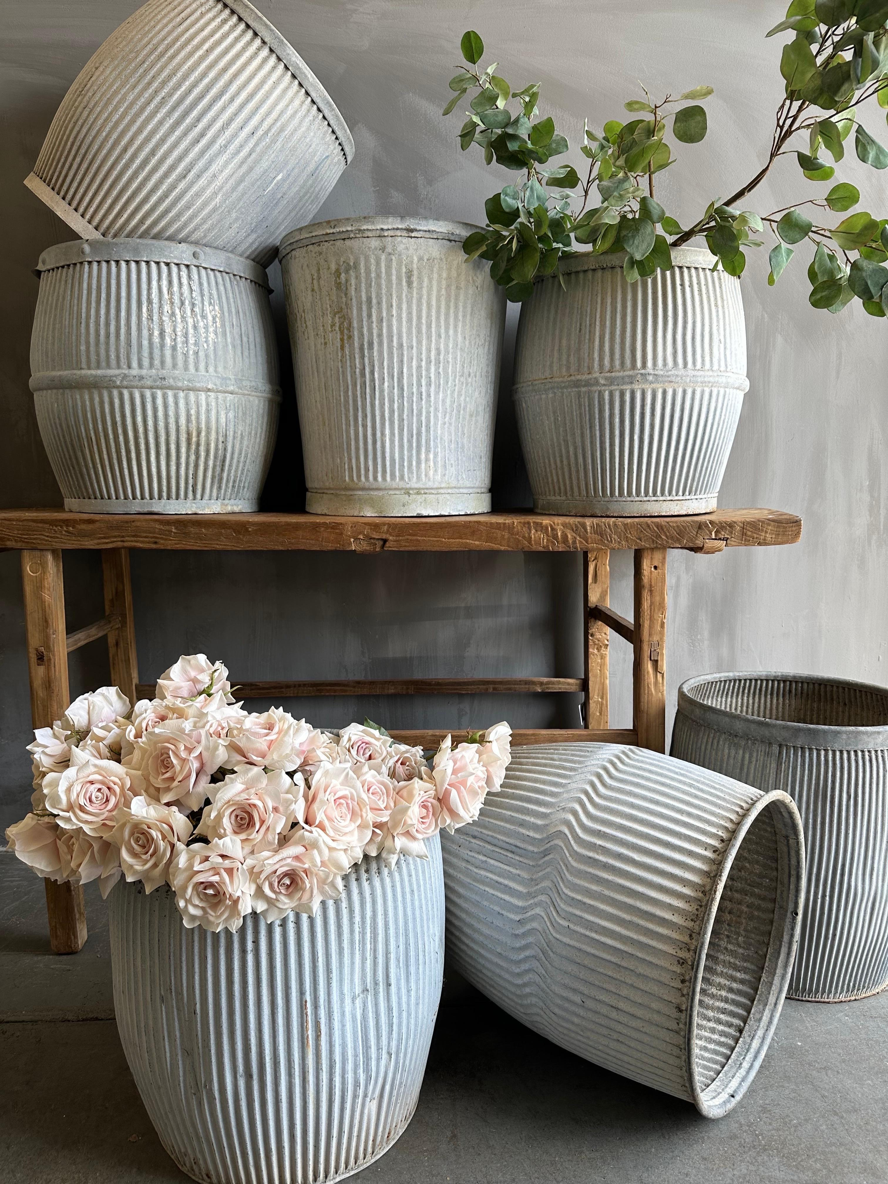 These European zinc barrels were once used in early 20th century England as a laundry alternative to the washboard, these antique, galvanized barrel with aged patina can be used for storage, planters, vessels for firewood, or easy organizers in the