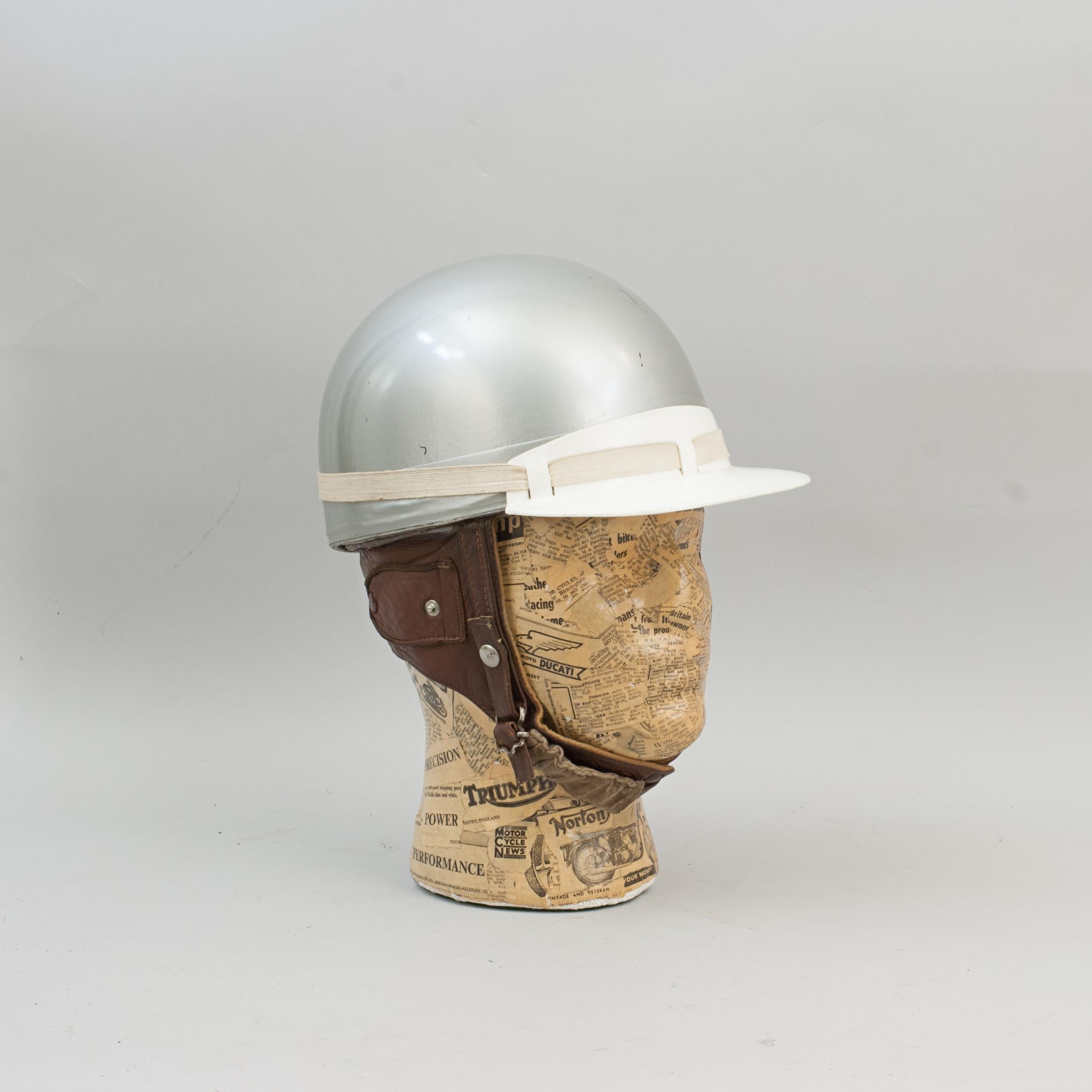 Vintage racing motorcycle crash helmet, Everoak.
A fine silver painted Motorcycle, Pudding basin shape helmet made in England by Everoak. This helmet has a cork interior, fitted with a leather headband and straps keeping a space between the head