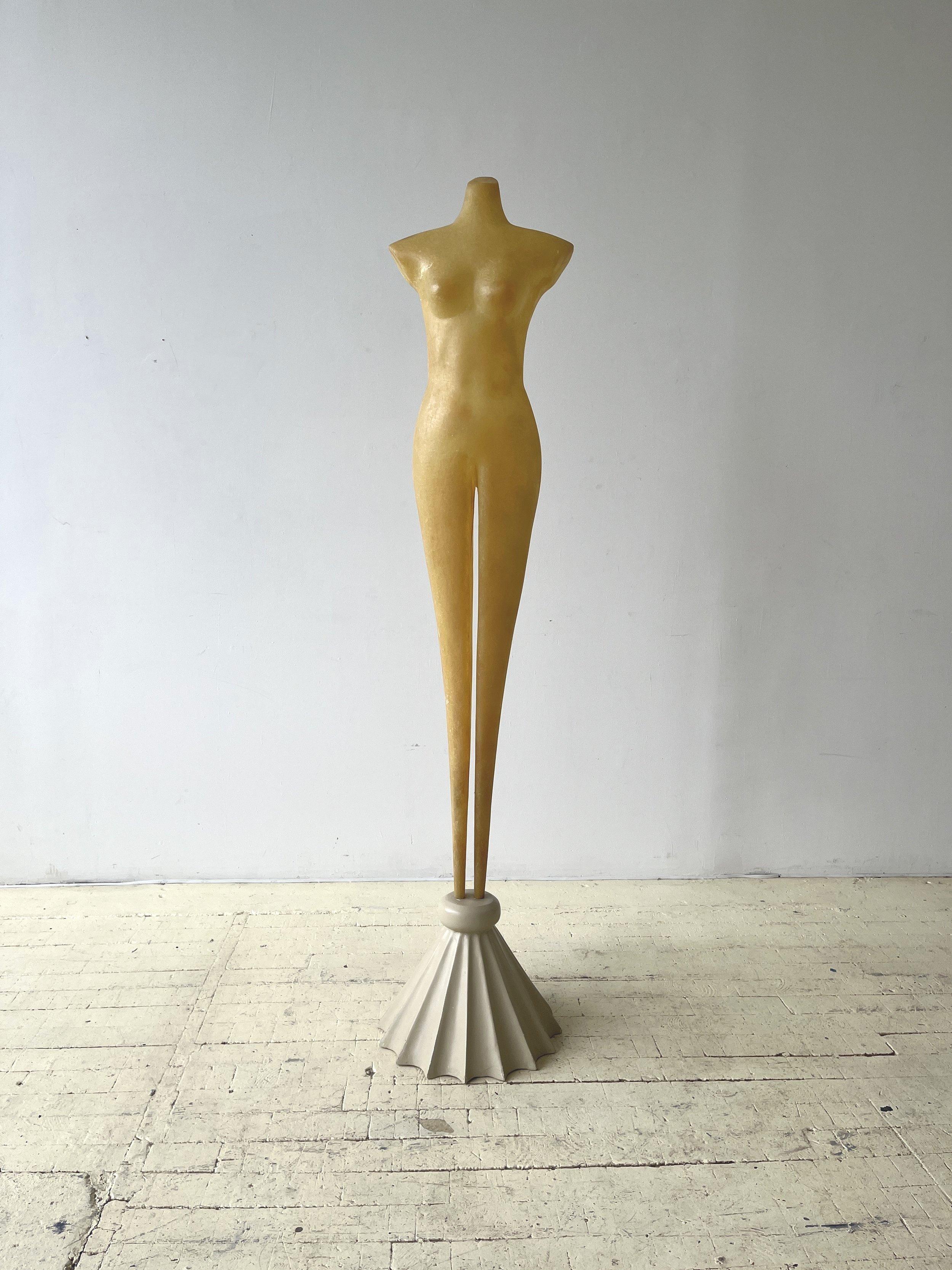 Vintage exaggerated Molded fiberglass Female body form on fluted base, circa 1970s. Abstract molded fiberglass female form with nipped proportions and elongated, tapered legs. The body of the piece is formed from two molded sections, front and back,