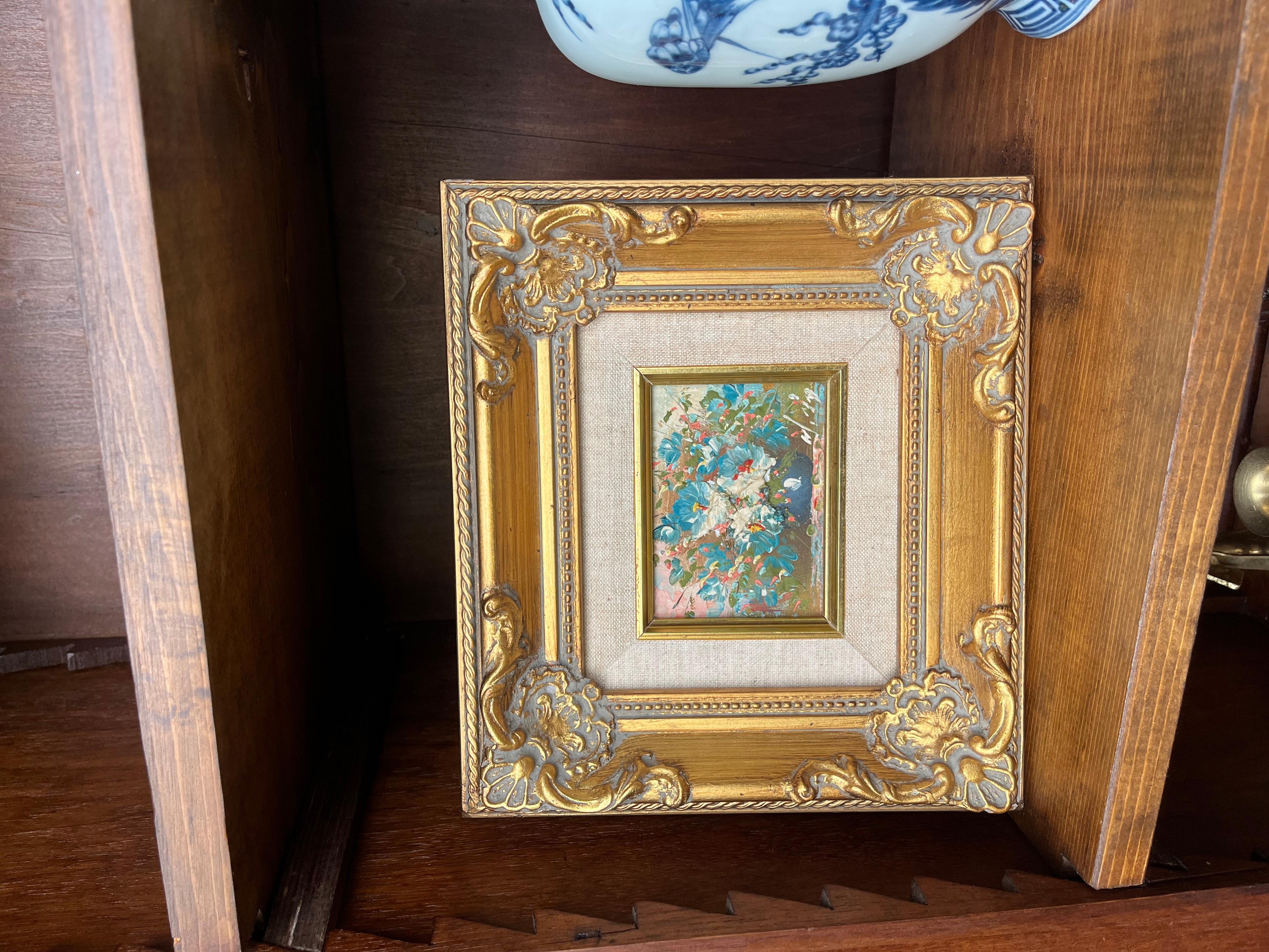 This exquisite miniature floral painting, a vibrant oil on board, originated from a distinguished estate in Richmond, VA, where it adorned the walls of a charming residence. The piece showcases an enchanting array of colorful blossoms, capturing the