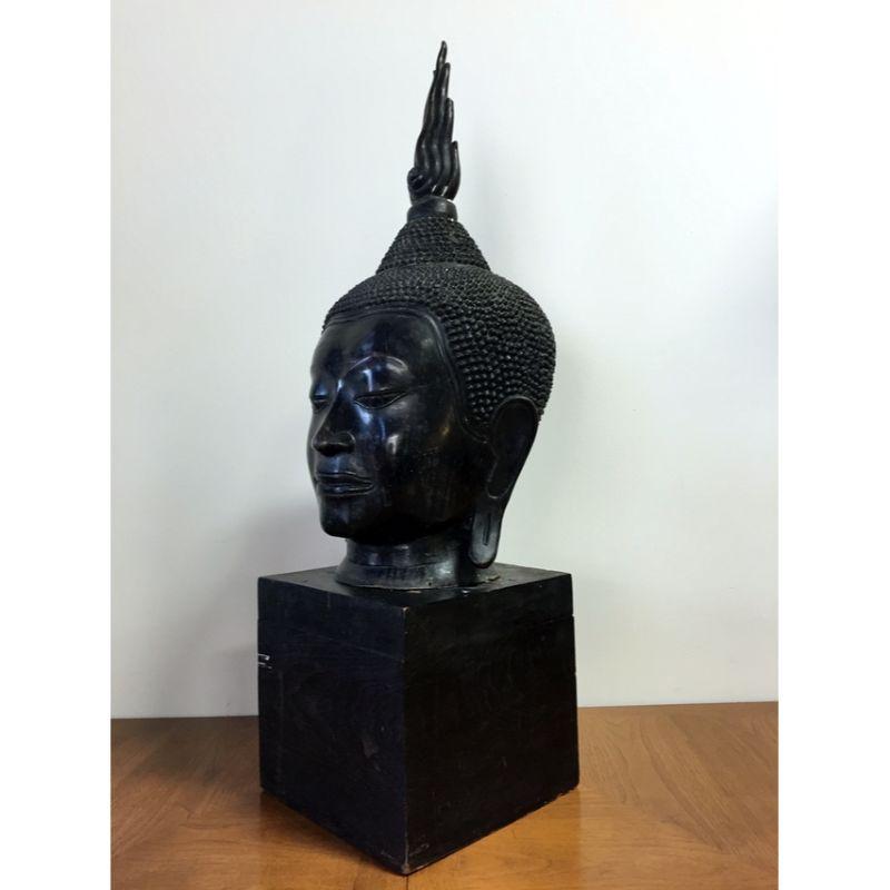 For your consideration a giant buddha head sculpture. Made from ceramic or metal, or a combination of both. Painted black. Sits on a wooden base. As this piece is unsigned, the artist is unknown. Age is unknown. This piece comes from a South Florida