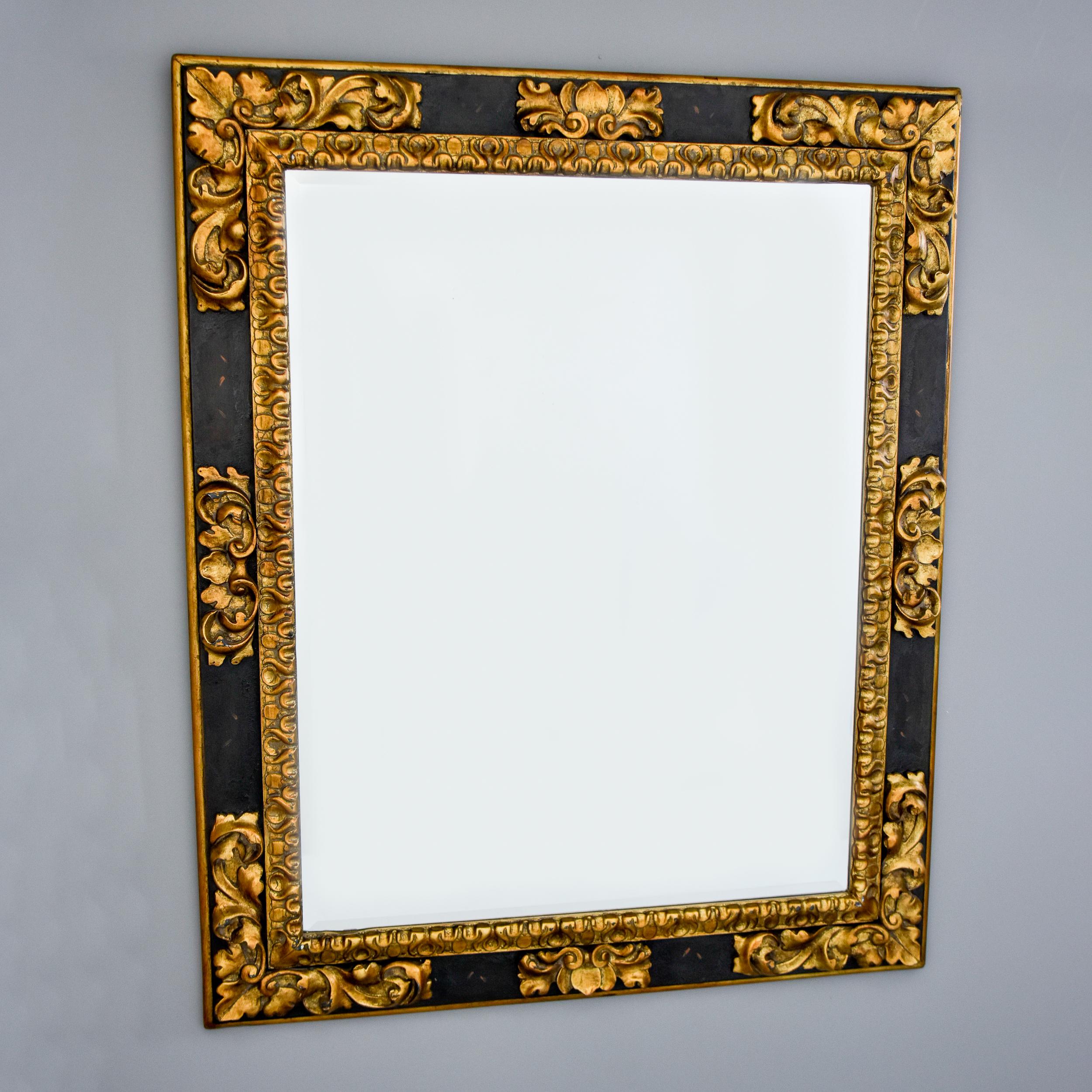 Found in the US, this extra large vintage mirror by Ralph Lauren Polo dates from the 1990s. Rectangular mirror has a beveled edge and sits in a black and gilt wood frame with decorative foliate corners and a giltwood inner border. Actual Mirror
