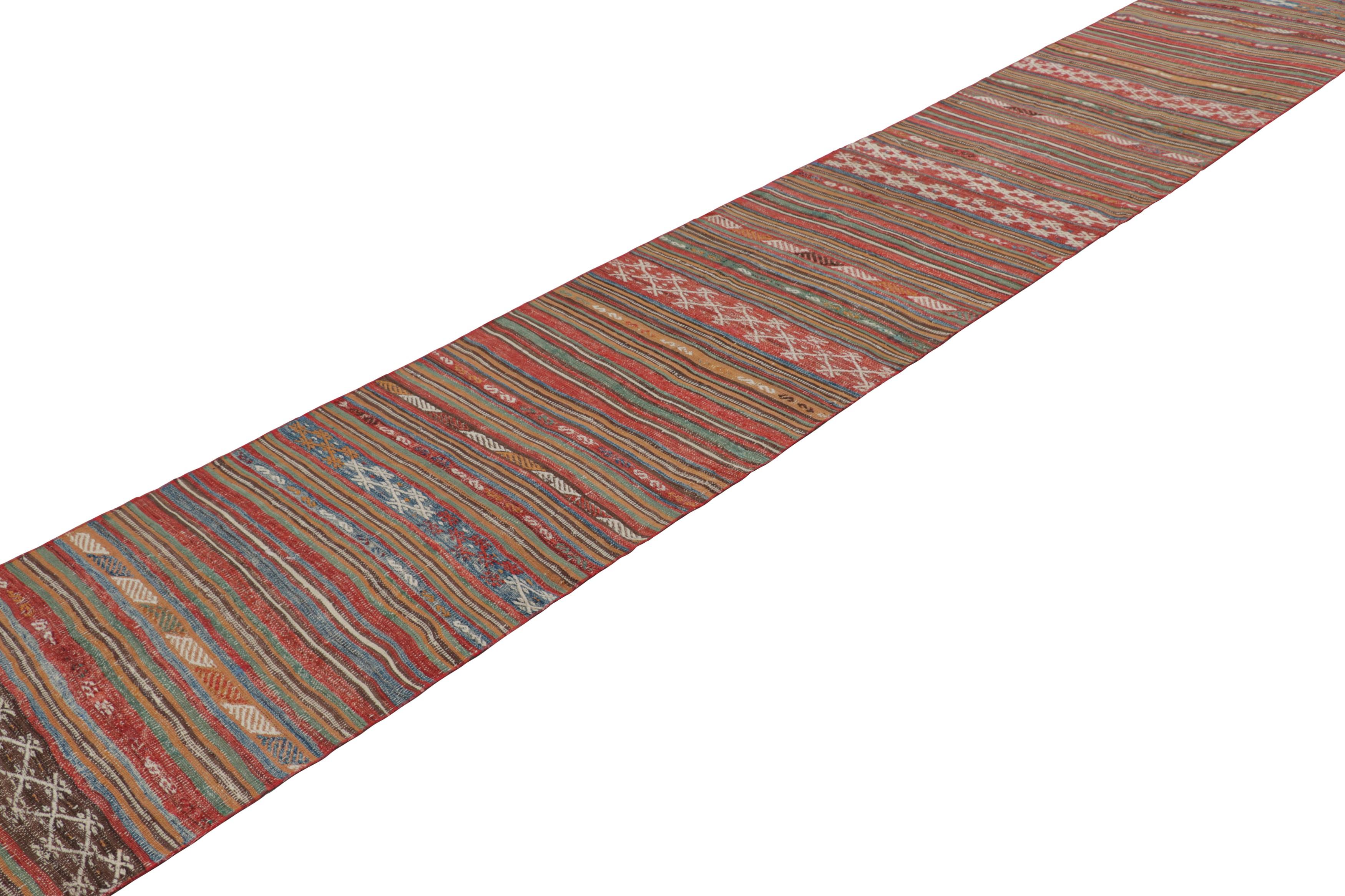 Made with handwoven wool in Turkey circa 1950-1960, this 2x22 vintage Kilim and extra-long runner rug is a rare and exciting new addition to Rug & Kilim’s curation of mid-century tribal kilims. 

On the Design: 

Brick red, navy blue, and