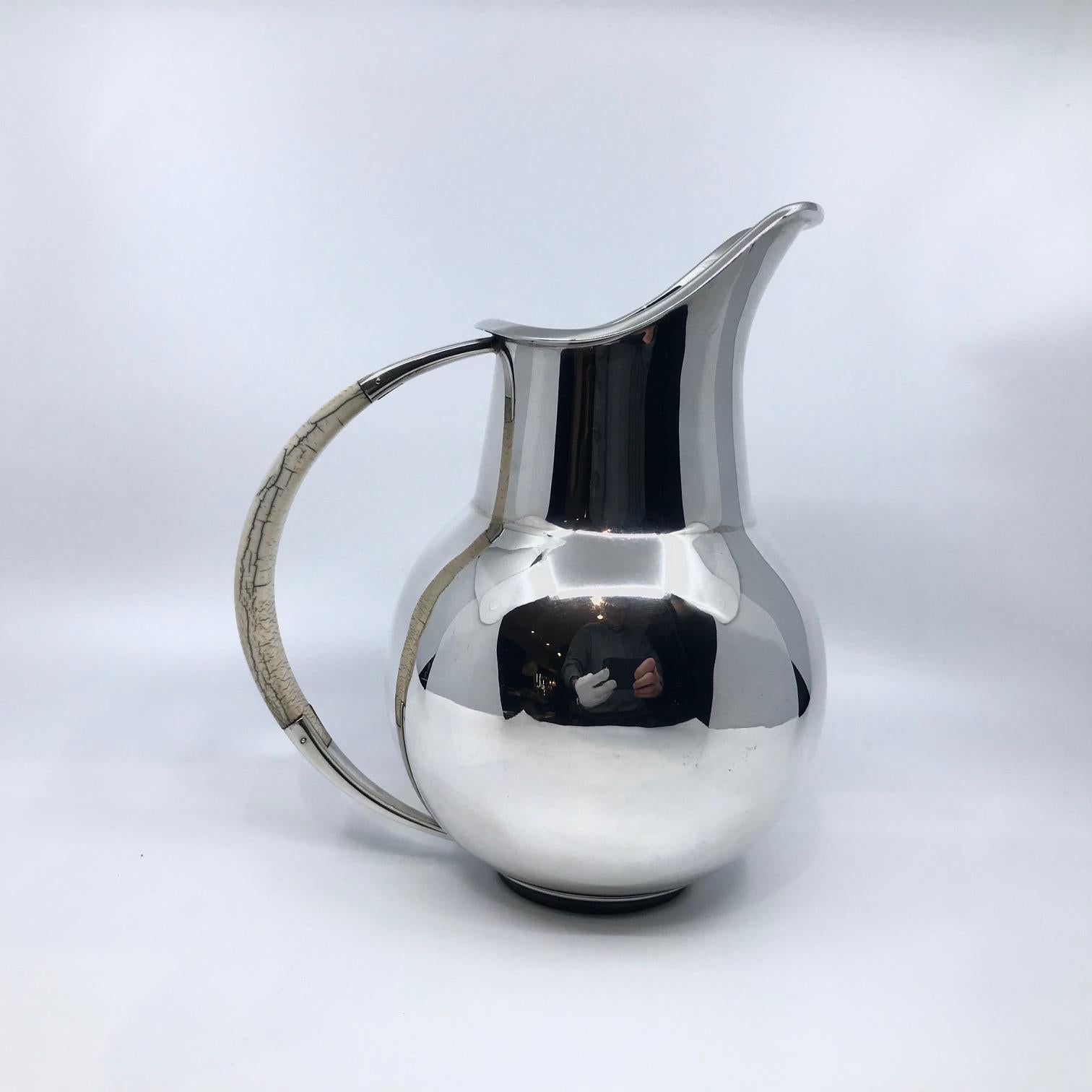 Sterling silver Mid-Century pitcher with ivory handle, design #204 by Svend Weihrauch from 1941. Elegant Mid-Century design, F. Hingelberg was one of the premier silvers makers in Denmark at the time, their hand craftsmanship is of the absolute