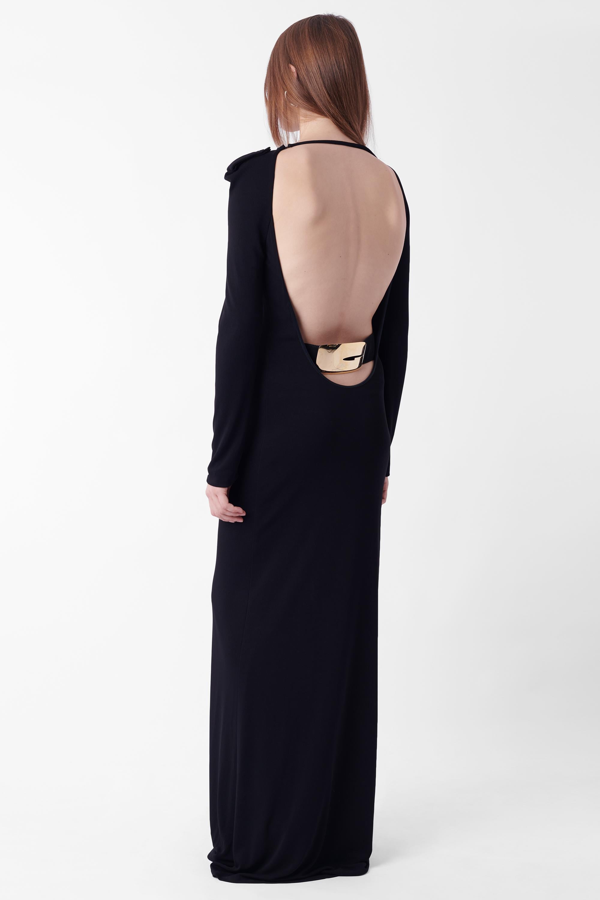 Tom Ford for Gucci Fall Winter 1996 black dress, runway look 46. Comes with the iconic gold belt, as seen on the runway, with ‘Gucci’ engraving. Features deep open back, long sleeves, epaulettes with button closure, top back string closure and fully