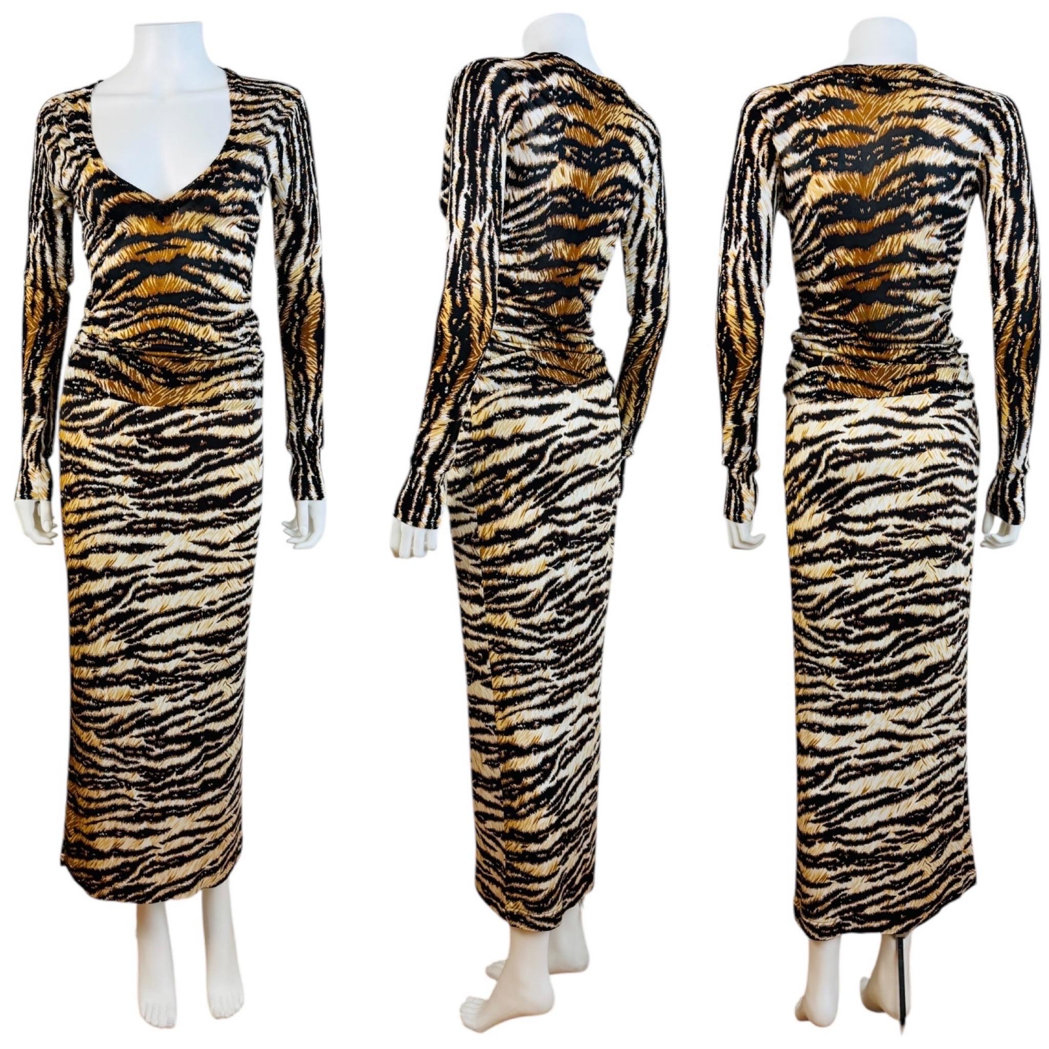 Stunning F/W 1999 Dolce + Gabbana Set
Bold tiger print knit
Long tapered sleeves
Deep V neckline
Fitted style
Viscose + polyester
Unlined
Slips on overhead

Matching skirt
Viscose material
Wiggle style maxi length
Hidden zipper at the left