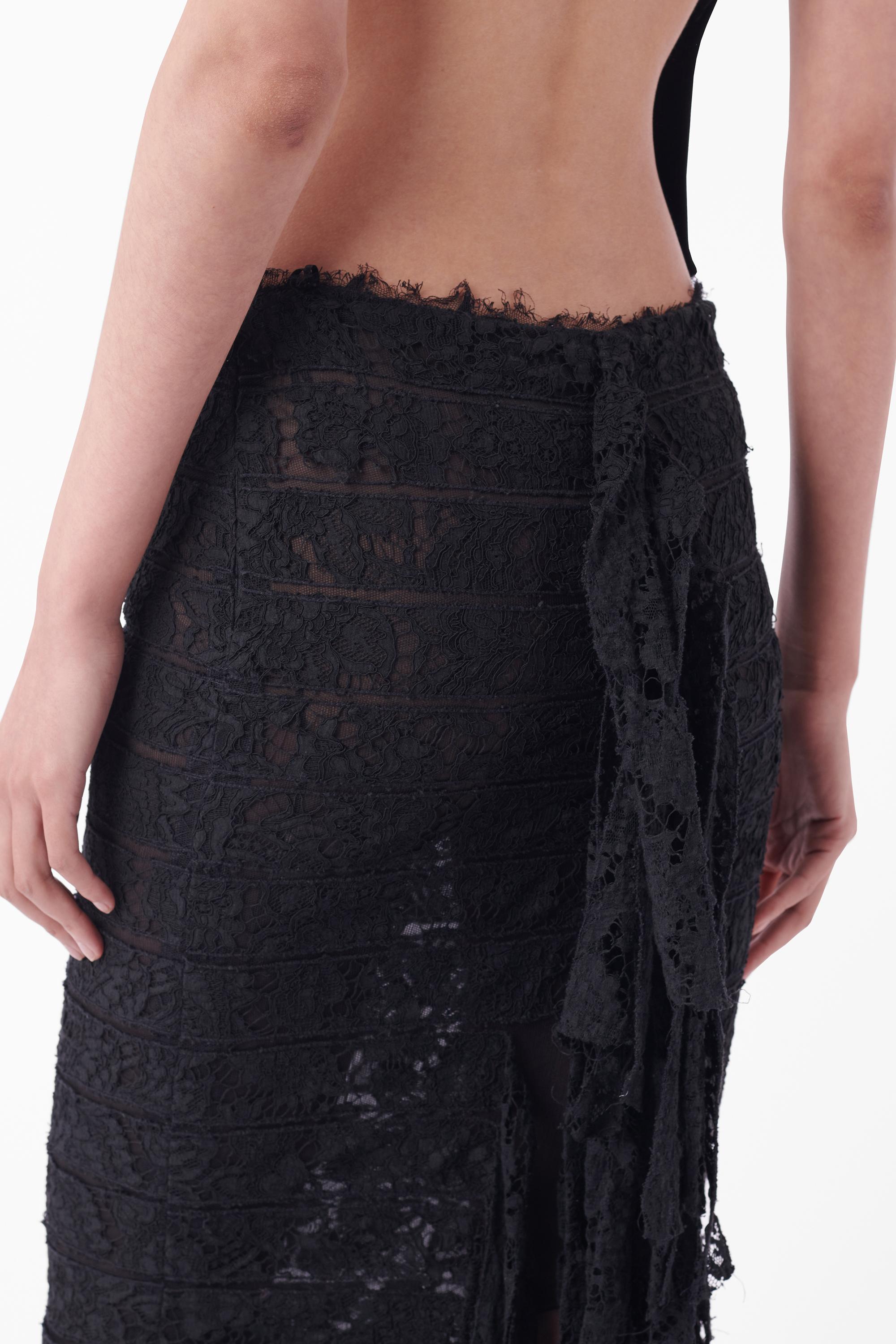 We are excited to present this Tom Ford for Yves Saint Laurent Fall Winter 2002 lace skirt. Similar to that seen on the season's runway. Features horizontal sheer lace panelling, raw hemline finishes, lace ruffle back, mesh lining and invisible zip