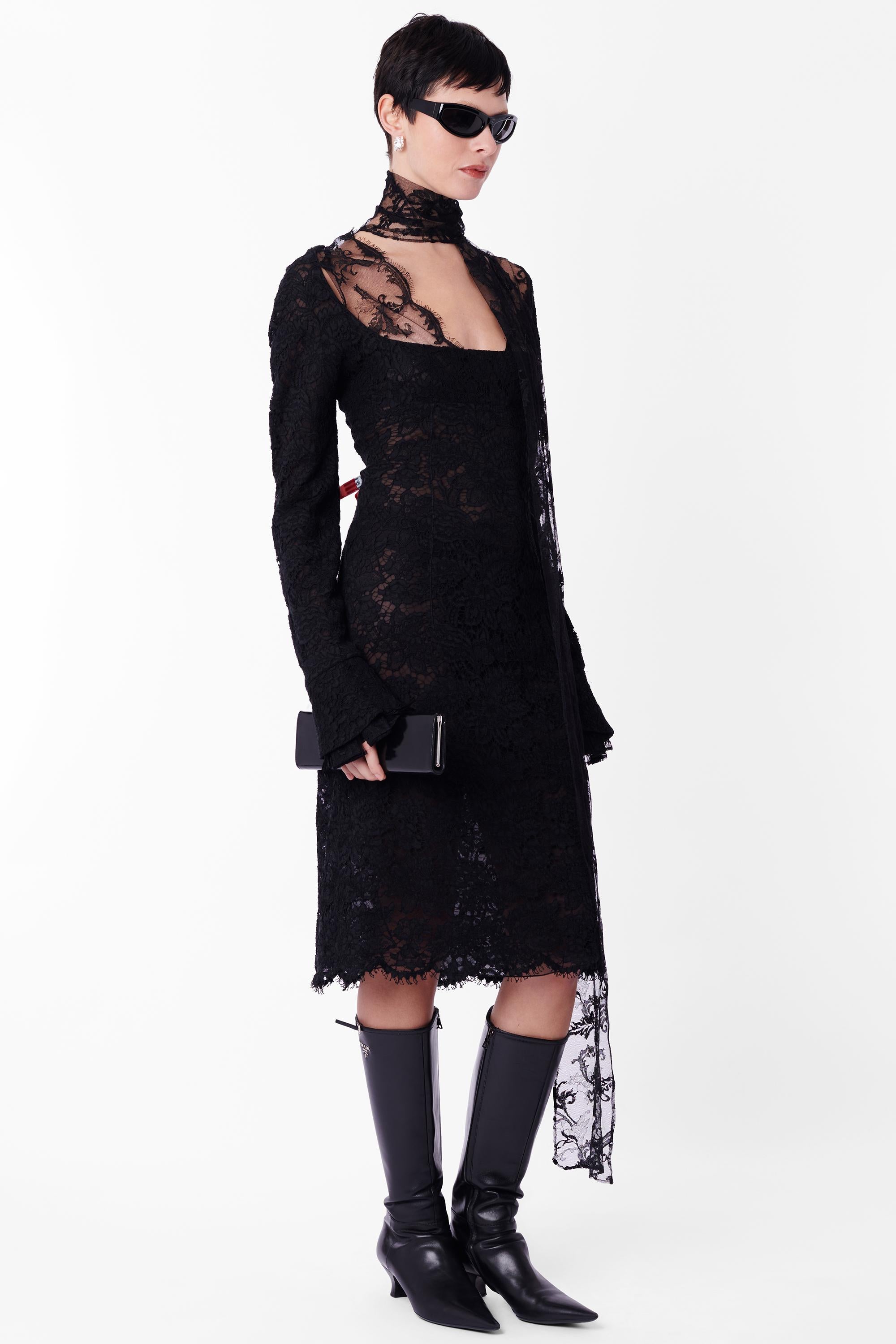 Vintage Yves Saint Laurent by Tom Ford Fall Winter 2002 rare black guipure lace dress. As seen on the runway, look 33. Features guipure lace body, long sleeves with pleated cuffs, open square neck lined with lace trim, connected lace scarf that can