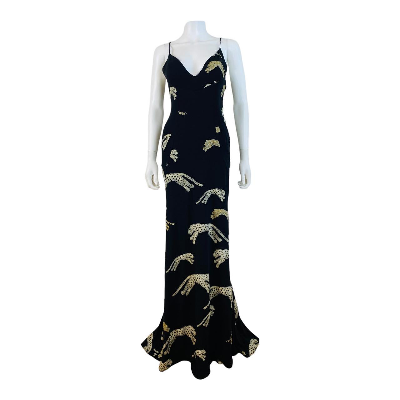 Stunning F/W 2002 Roberto Cavalli dress gown
Black stretch silk fabric with white leopards throughout
Metallic painted look effect on leopards + green metallic eyes
V neckline
Fitted bust detail
Long form fitted style
Flared