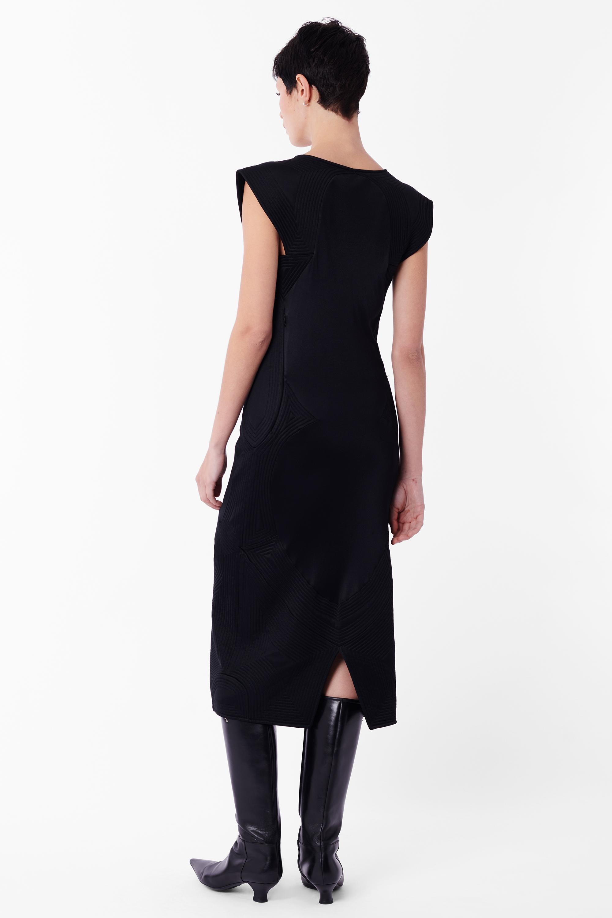 Vintage Tom Ford for Yves Saint Laurent Fall Winter 2004 black midi dress. Features seamed cap sleeves, thick seamed sides, tie up detailing on front right chest and back slit in a midi length. In excellent vintage condition. Authenticity