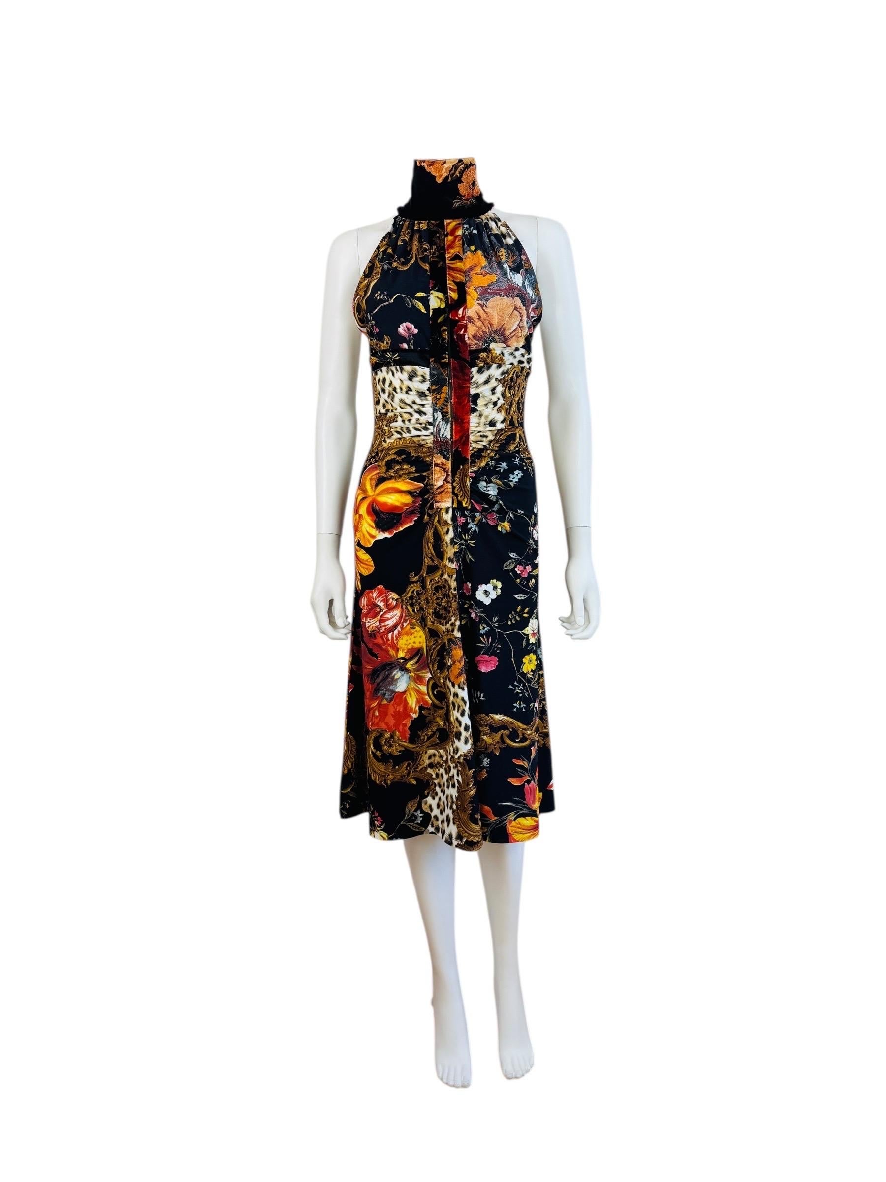Early 2000s 2005 Roberto Cavalli Dress
Black stretch viscose knit fabric with velvet trim matching fabric
High collared neckline with gold buttons at the back of the neck
Sleeveless
Fitted bust with keyhole cut out
Hook closures up the front about