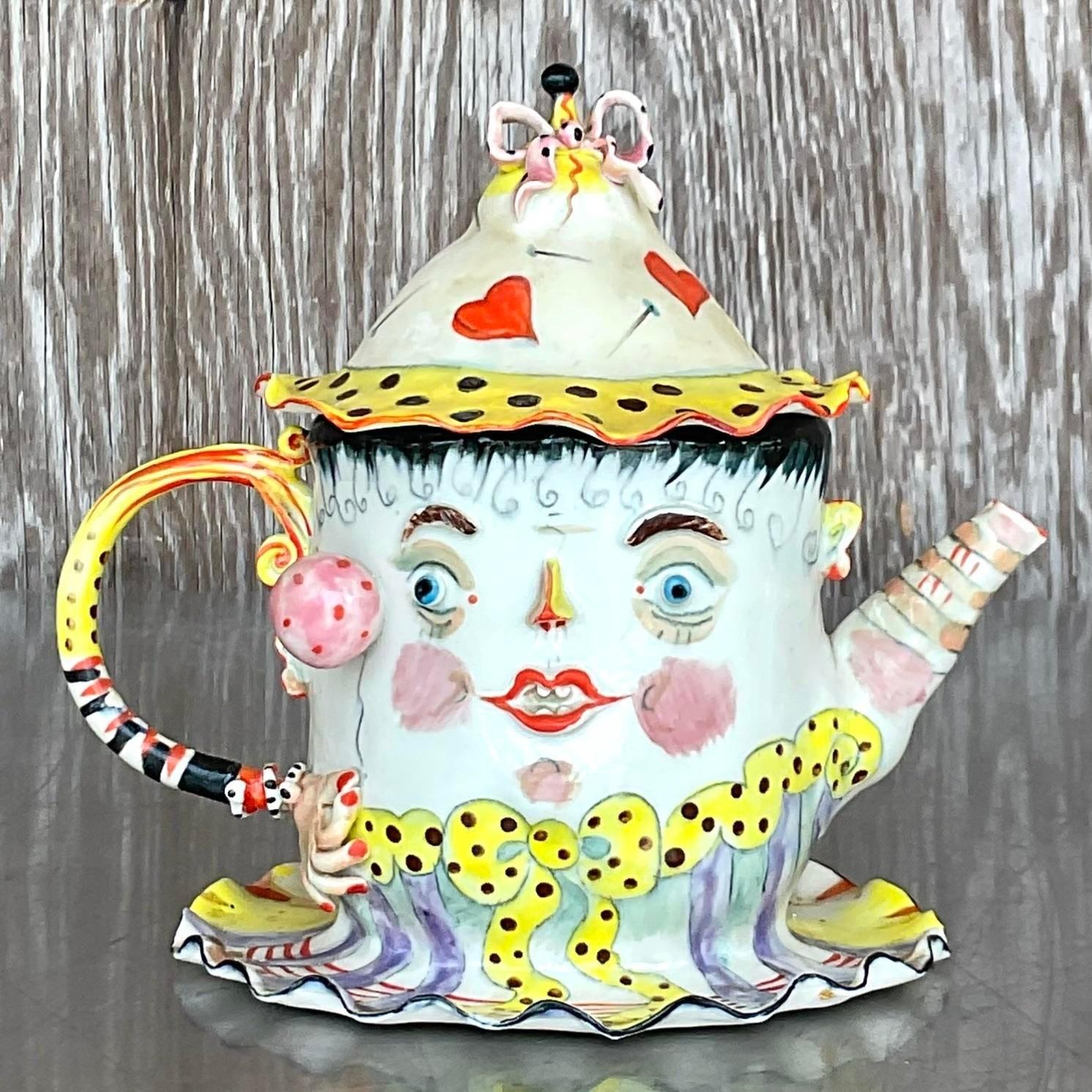 A stunning and unique vintage teapot with an arrangement of colors painted on its ceramic surface. Acquired at a Palm Beach estate.