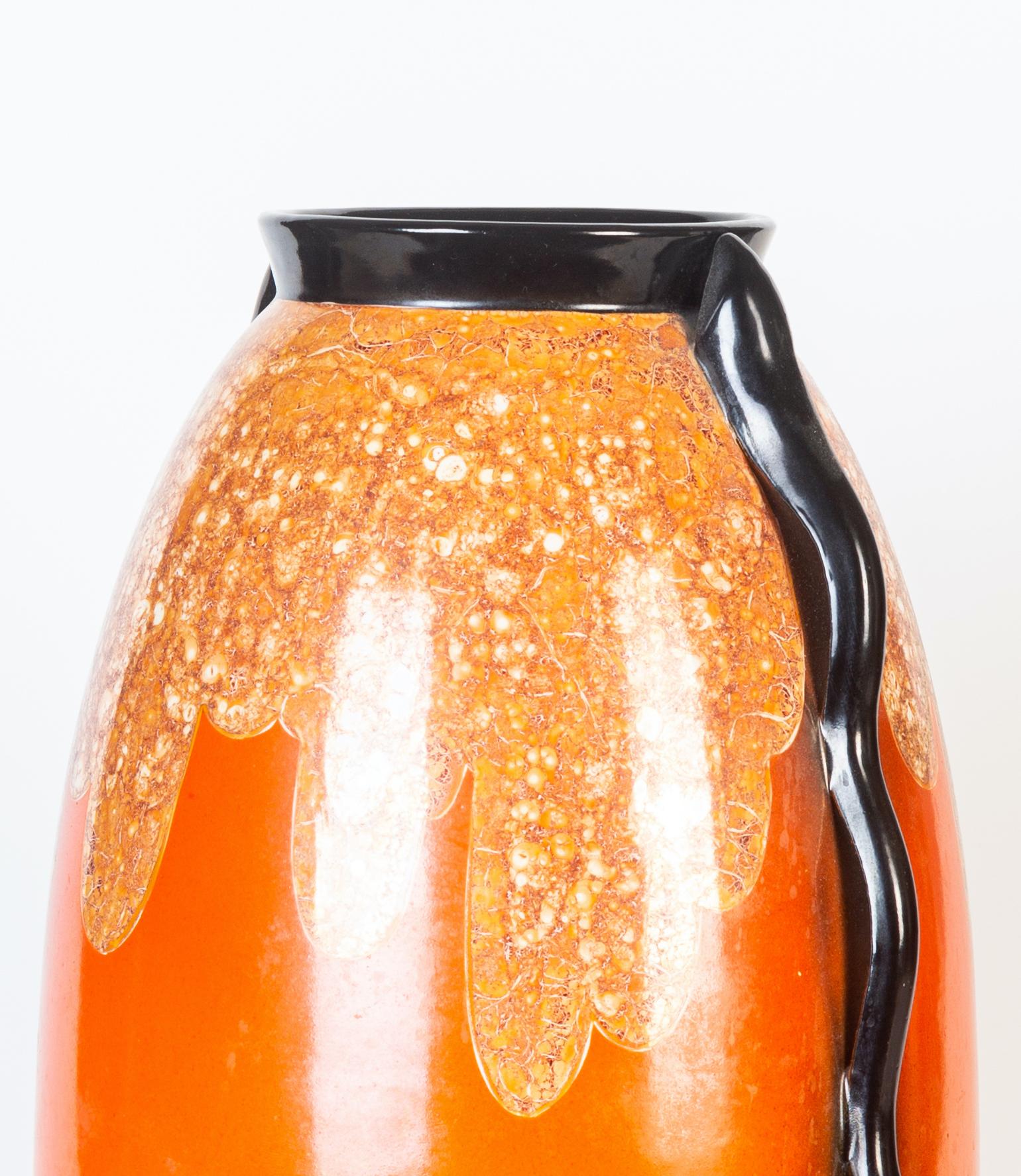 F.A.C.I ceramic vase is a vintage ceramic decorative object, realized during the 1950s. 

A beautiful orange vase with a decoration on the higher part of the body and with black edge and handles.

This vase was realized by 