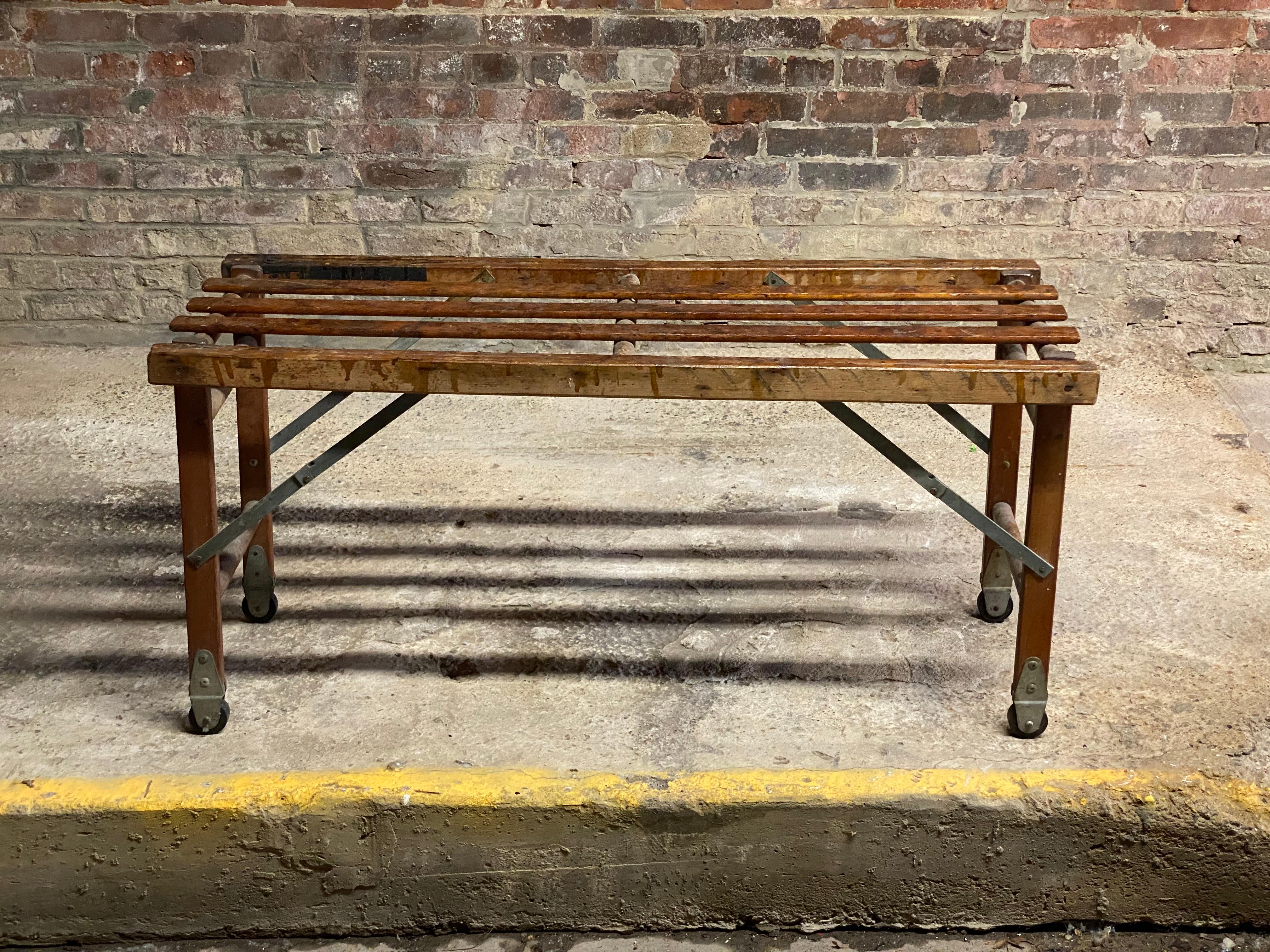 Vintage factory or work sight folding and rolling slatted stand much like the vintage folding wallpaper tables I've seen and owned before, but significantly smaller. Circa 1930. Folds up flat, hard rubber wheels and would work anywhere in the
