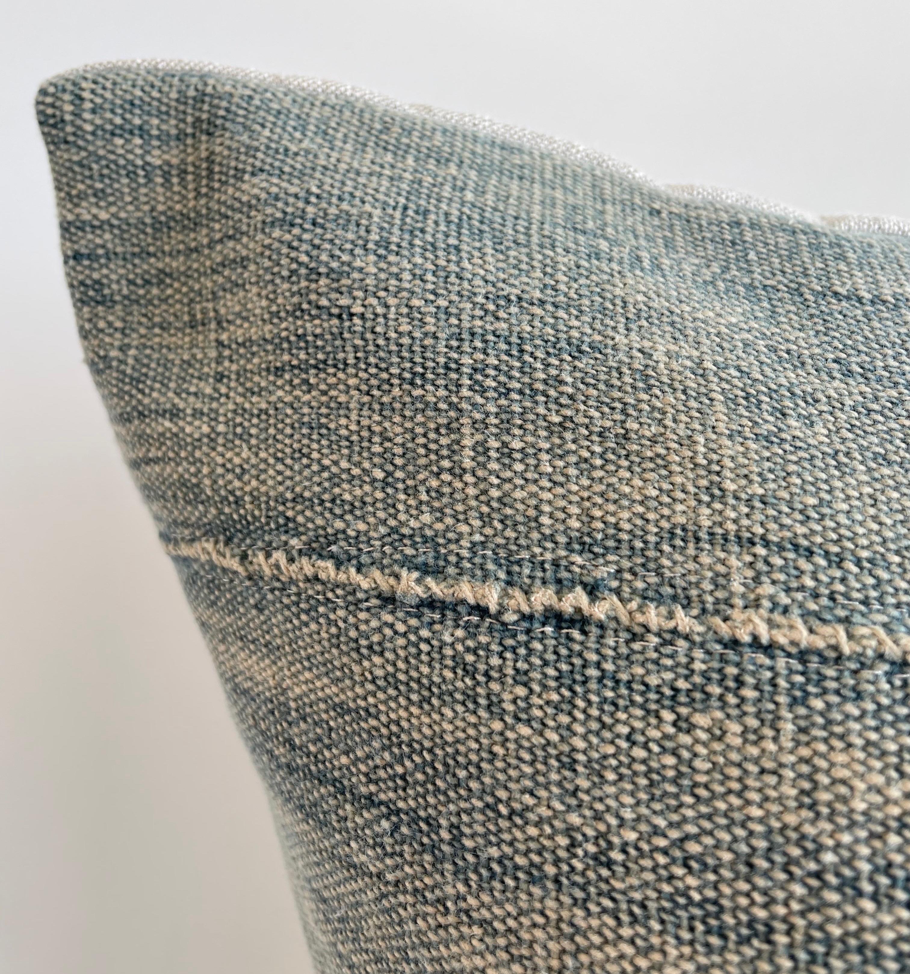 Antique faded blue indigo stripe African mudcloth pillows with original fringe details. Fabric: Vintage hemp fabric front, natural colored linen fabric back. Due to the nature of vintage textiles, there may be fading or markings. While they add to