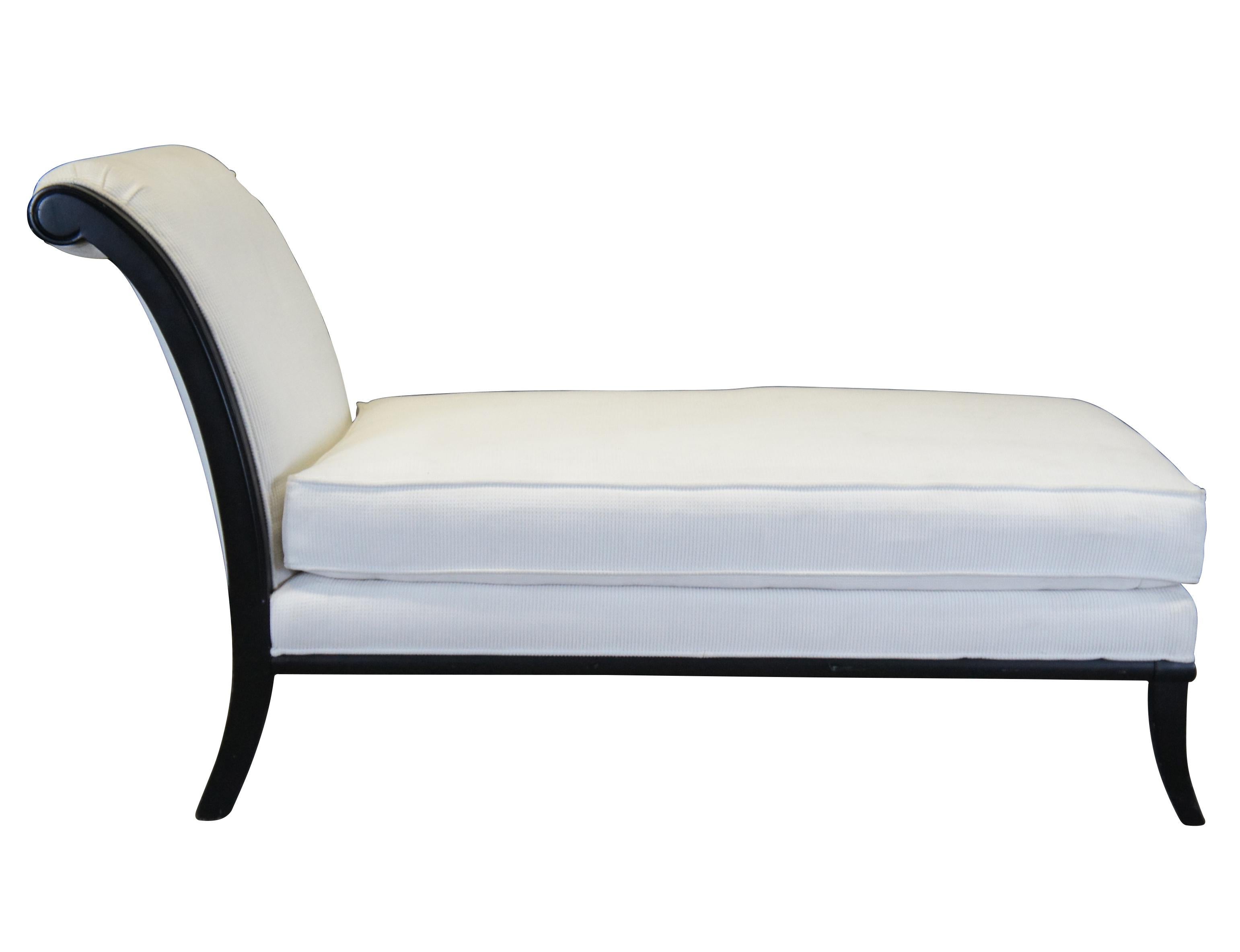 A lovely French inspired chaise lounge by Fairfield, circa 1990s. Features a black frame with a contoured back, white upholstery and saber legs. A comfy addition to any space. Measure: 64