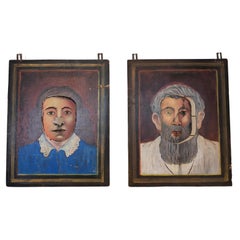 Vintage fairground male & female portraits with hinged faces & cut-out nose/eye