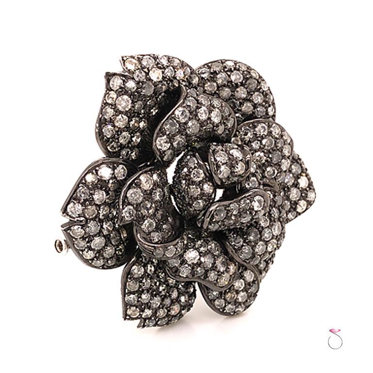 Gorgeous vintage diamond rose brooch in 18K white. This is a stunning brooch of a rose covered in fancy gray round diamonds in a beautiful 3D design. The diamonds are pave' set covering all the rose petals. A total of 8.80 carats of round fancy gray