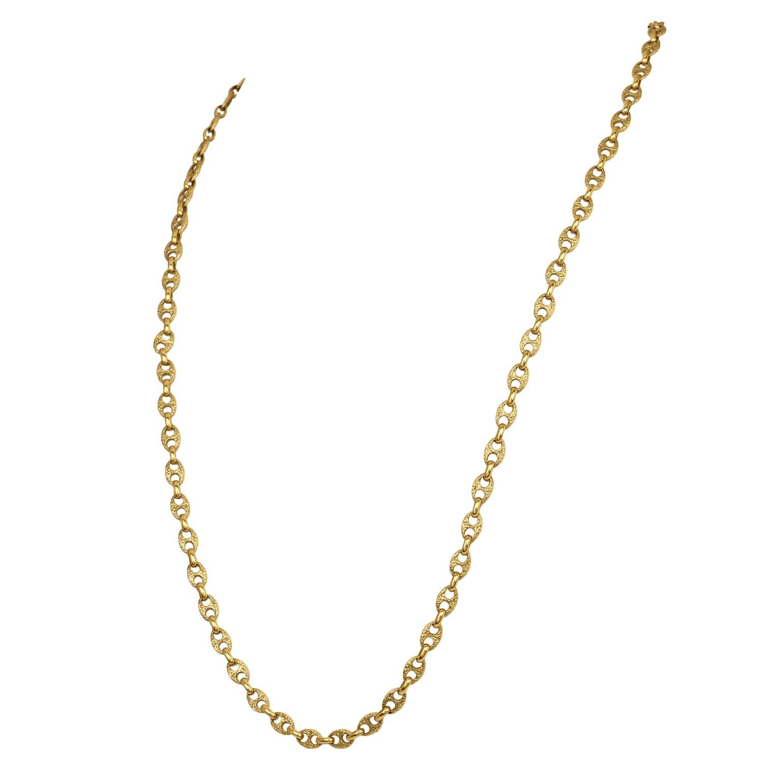 A timeless piece of fine jewelry, this elegant Guchi link chain necklace is crafted in solid 18K yellow gold with a refined textured link design. The intricate pattern on each link creates depth and dimension, catching the light beautifully with
