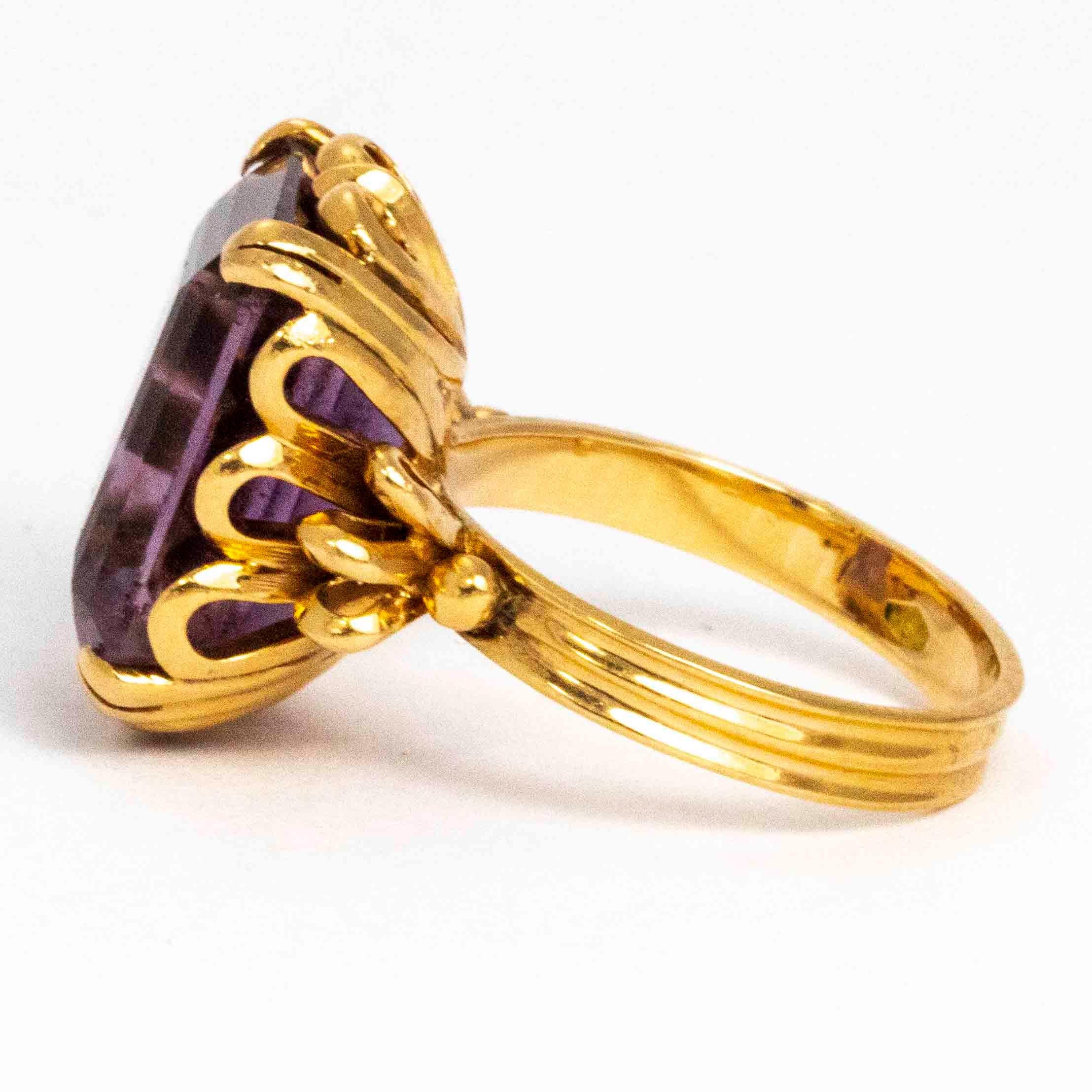 This Amethyst ring has the most wonderful setting! The 18carat gold is modelled into hearts and feature wonderful folds of gold either side of the purple stone. The size of this stone is absolutely perfect for a statement piece! 

Ring Size: K 1/2