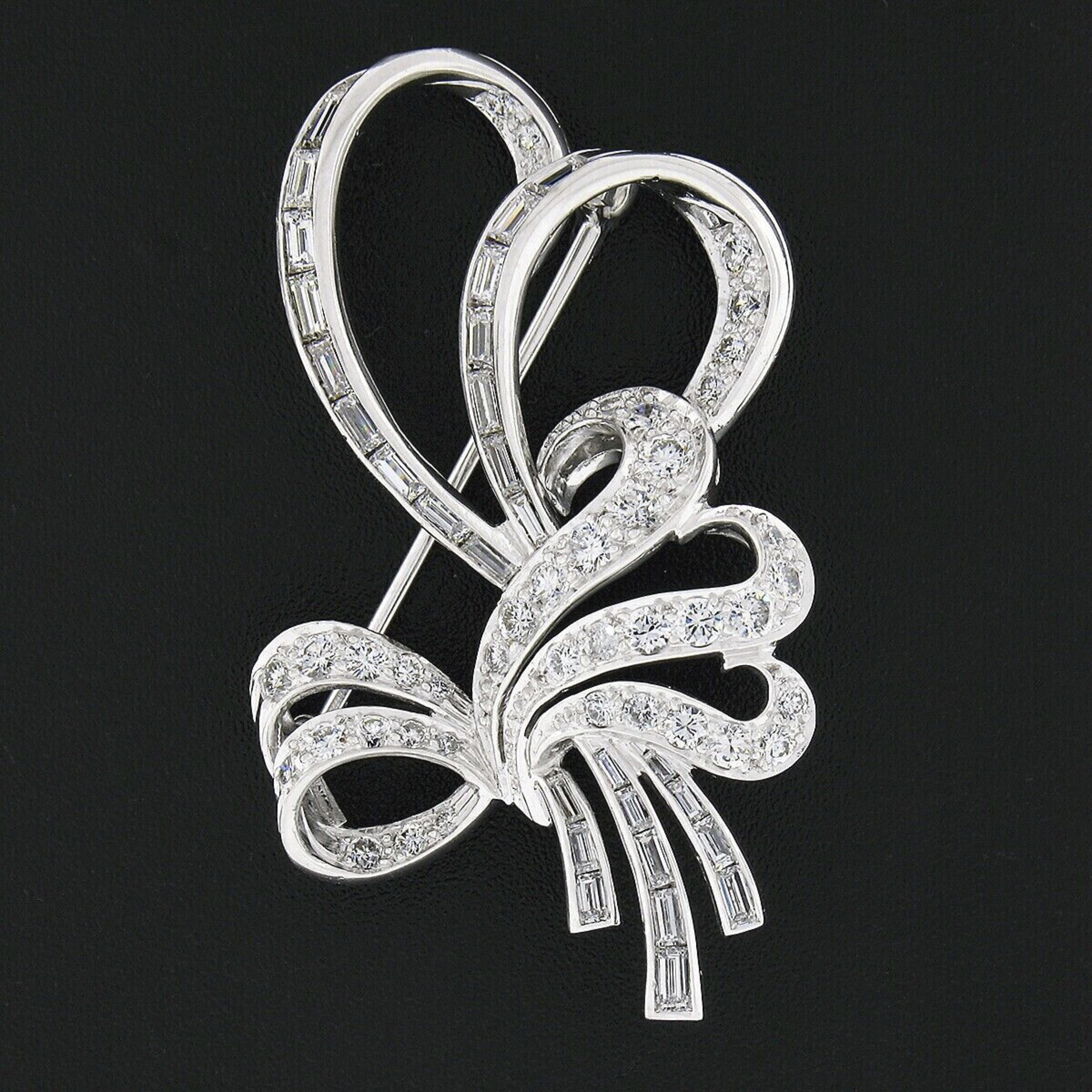 This magnificent, all original, vintage brooch was crafted from solid platinum and is completely drenched with stunning diamonds throughout its elegant, open, bow and ribbon design. These super fiery diamonds bring a truly glamorous look to this