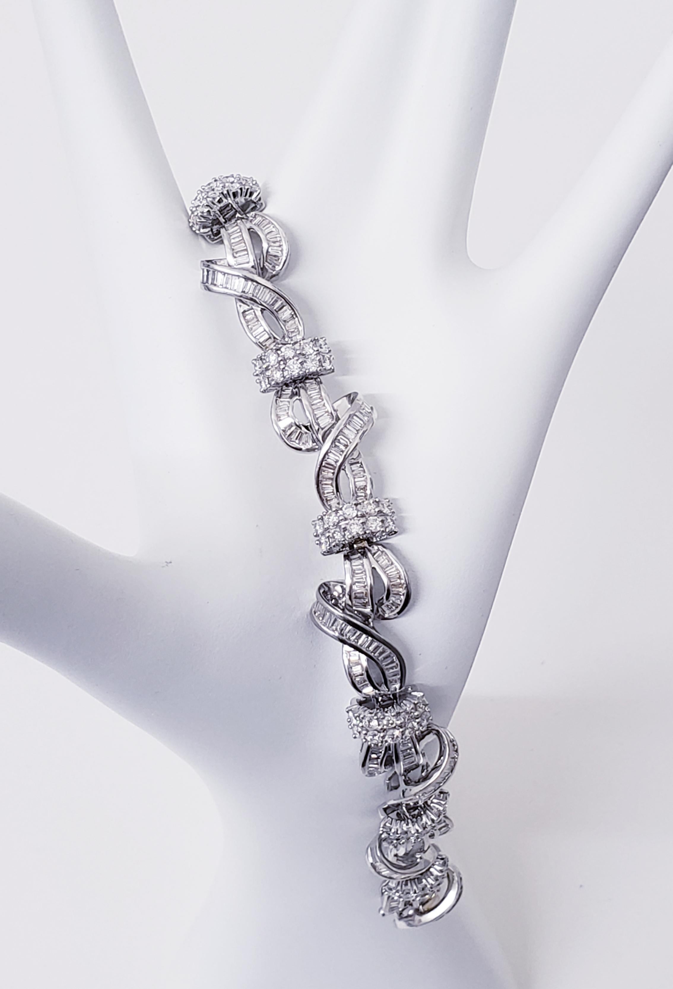 Vintage diamond bracelet in 14k white gold featuring 12.25TCW in round & baguette diamonds.
Swirls all around fully loaded with diamonds throughout. Gorgeous luxurious piece to own.
Circa 1980s 
