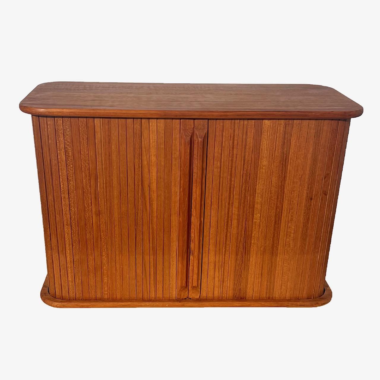For your consideration we offer this fantastic teak, well crafted, floating, vintage storage cabinet featuring tamboured doors. A clever, useful design incorporates flush mounting teardrop brackets for easy installation that fits snugly against a