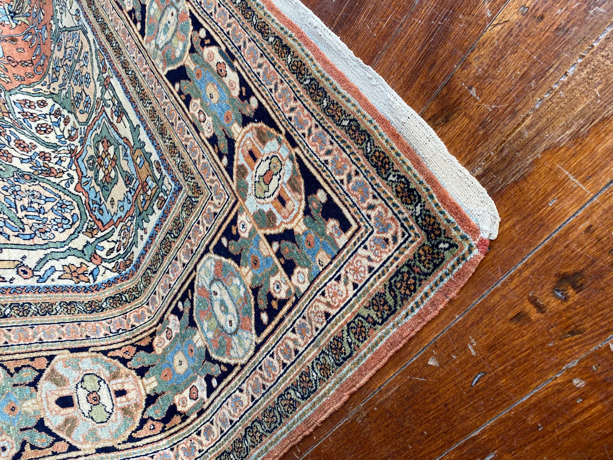 Immerse yourself in the captivating charm of the Early Twentieth Century Persian Farahan Rug. This remarkable rug showcases a beautiful vibrancy of colors, with a stunning ensemble of rich reds accompanied by pastel blues and greens. The combination