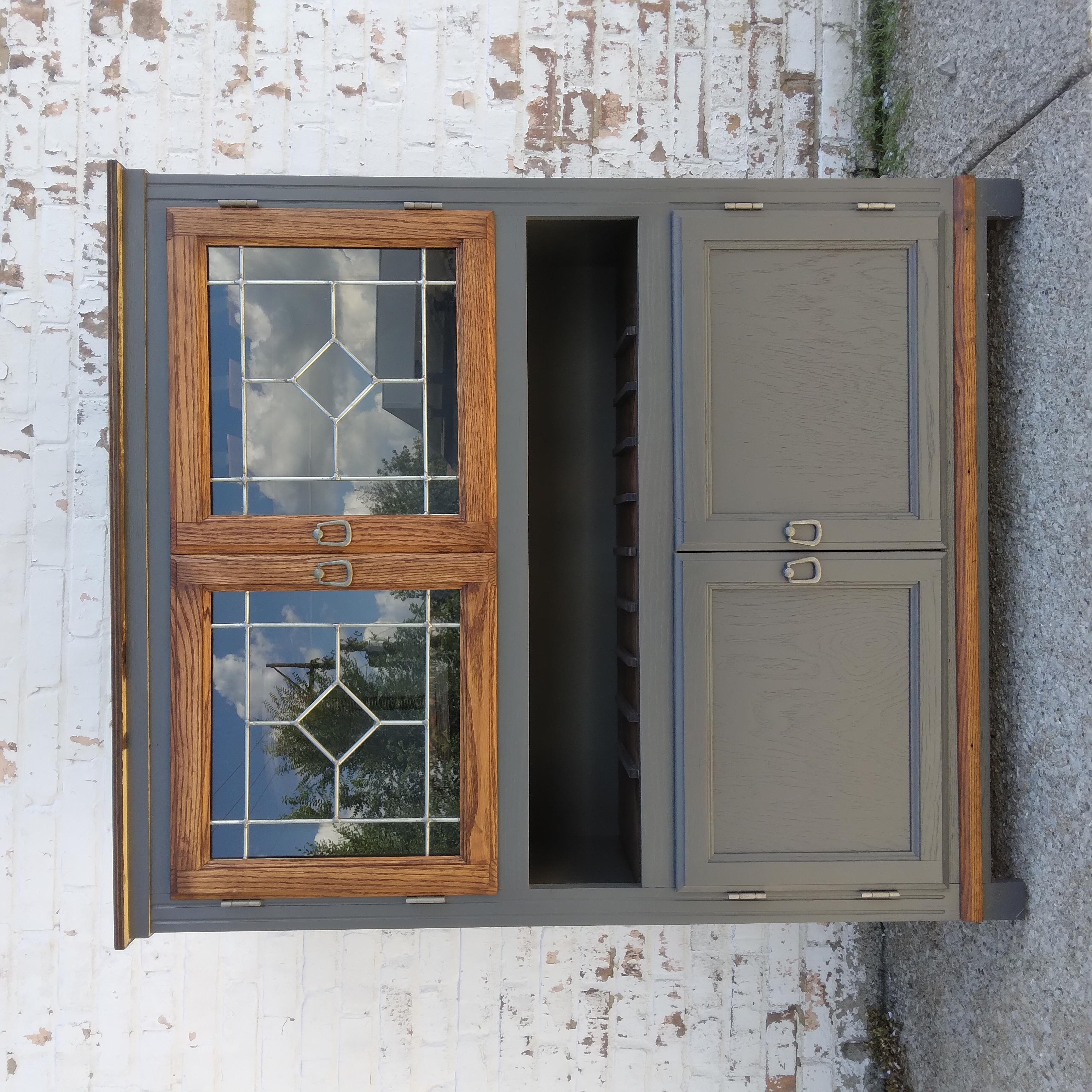 His industrial farmhouse bar cabinet is ready to find her new home. We love her paned windows and silver fixtures. Thinly veiled behind the transparent door is our favorite part -- a two-tiered rotary table for stemless glasses. She also contains