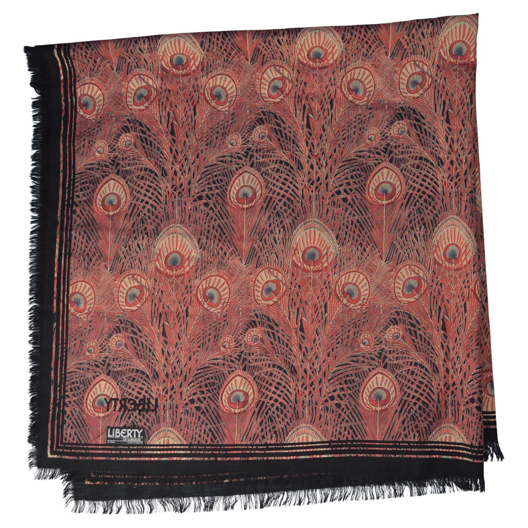 A splendid beautiful large popular Hera peacock design Shawl from Liberty of London with fringed edge in fine Varuna wool, printed in a gorgeous tones of Rust and Browns with peacock feather graphic design. A highly sought after and difficult to