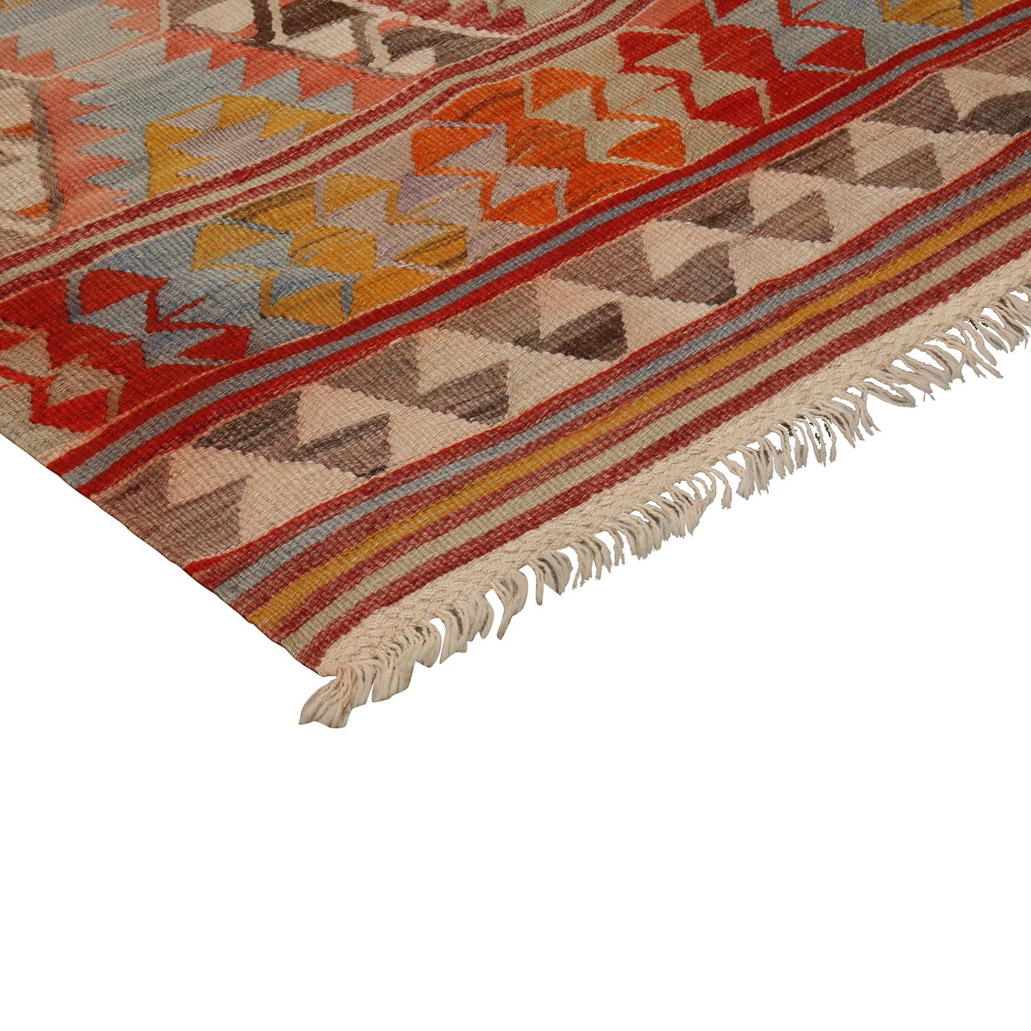 Flat-woven in high-quality wool originating from Turkey between 1930-1940, this vintage Fathiye Kilim rug hosts an intriguing pallet of vibrant rich and pastel colorways complementing a very Moroccan sense of joyful, tribal geometry, enjoying the