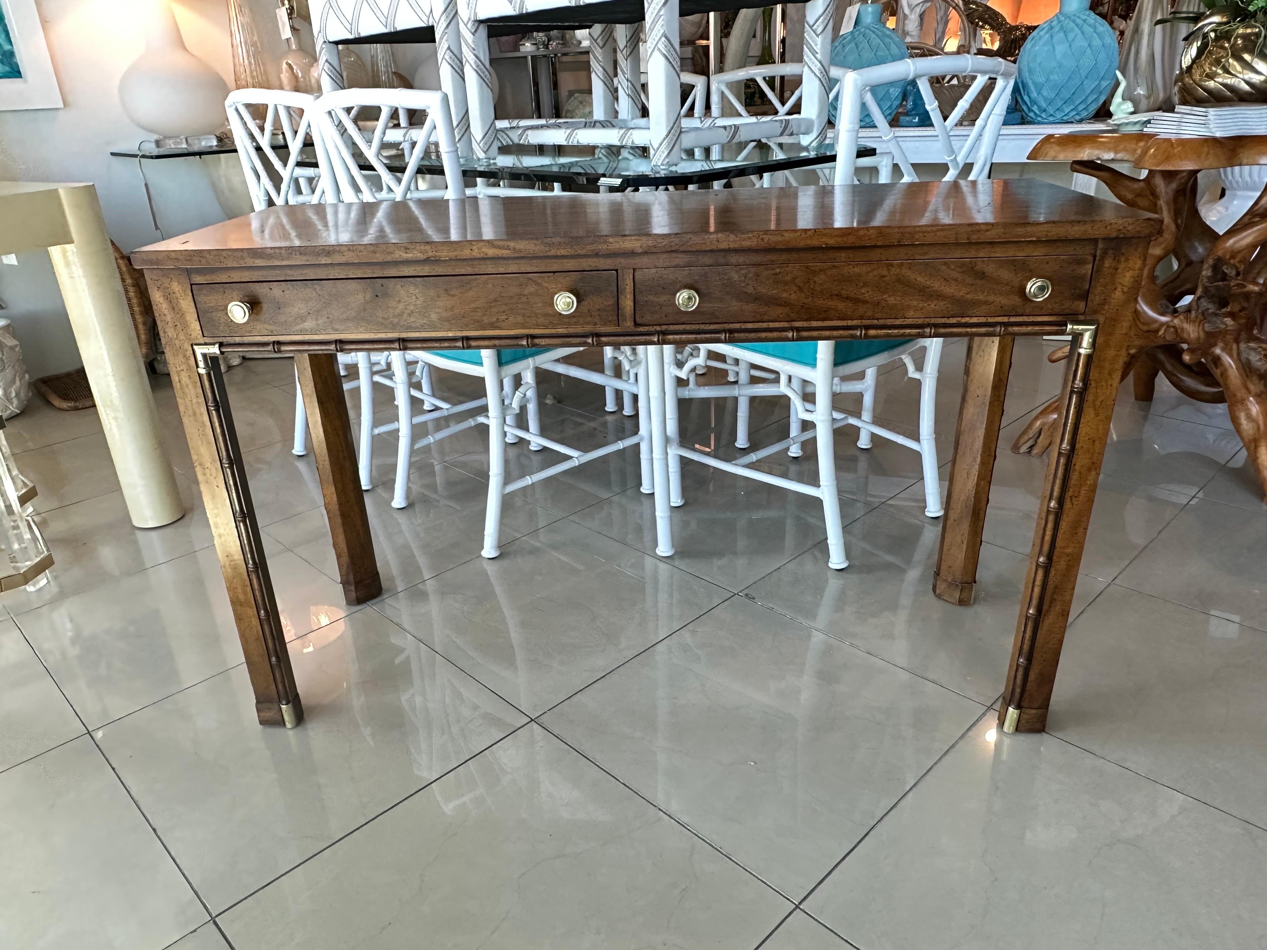 Vintage wood, faux bamboo & brass console table or desk with 2 drawers. Brass has been polished. Marked in drawer and underneath Weiman. Original wood finish has a few minor scratches/surface marks on top. Dimensions: 48 W x 17 D x 29.5 H.