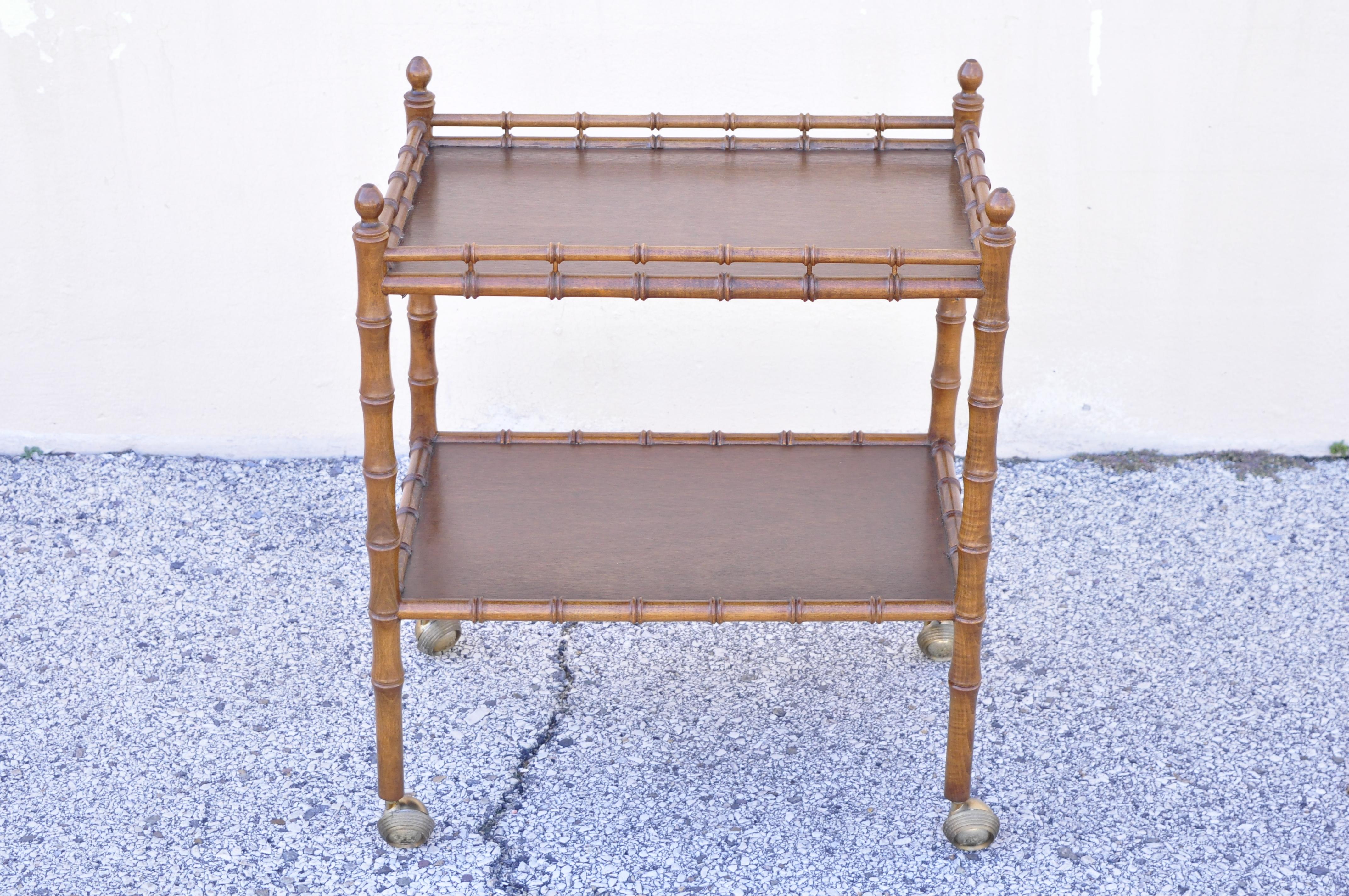 Vintage faux bamboo Chinese Chippendale Hollywood Regency wood bar cart server table. Item features rolling casters, 2 tiers shelves, carved faux bamboo frame, very nice vintage item, great style and form. Circa mid 20th century. Measurements: 29.5