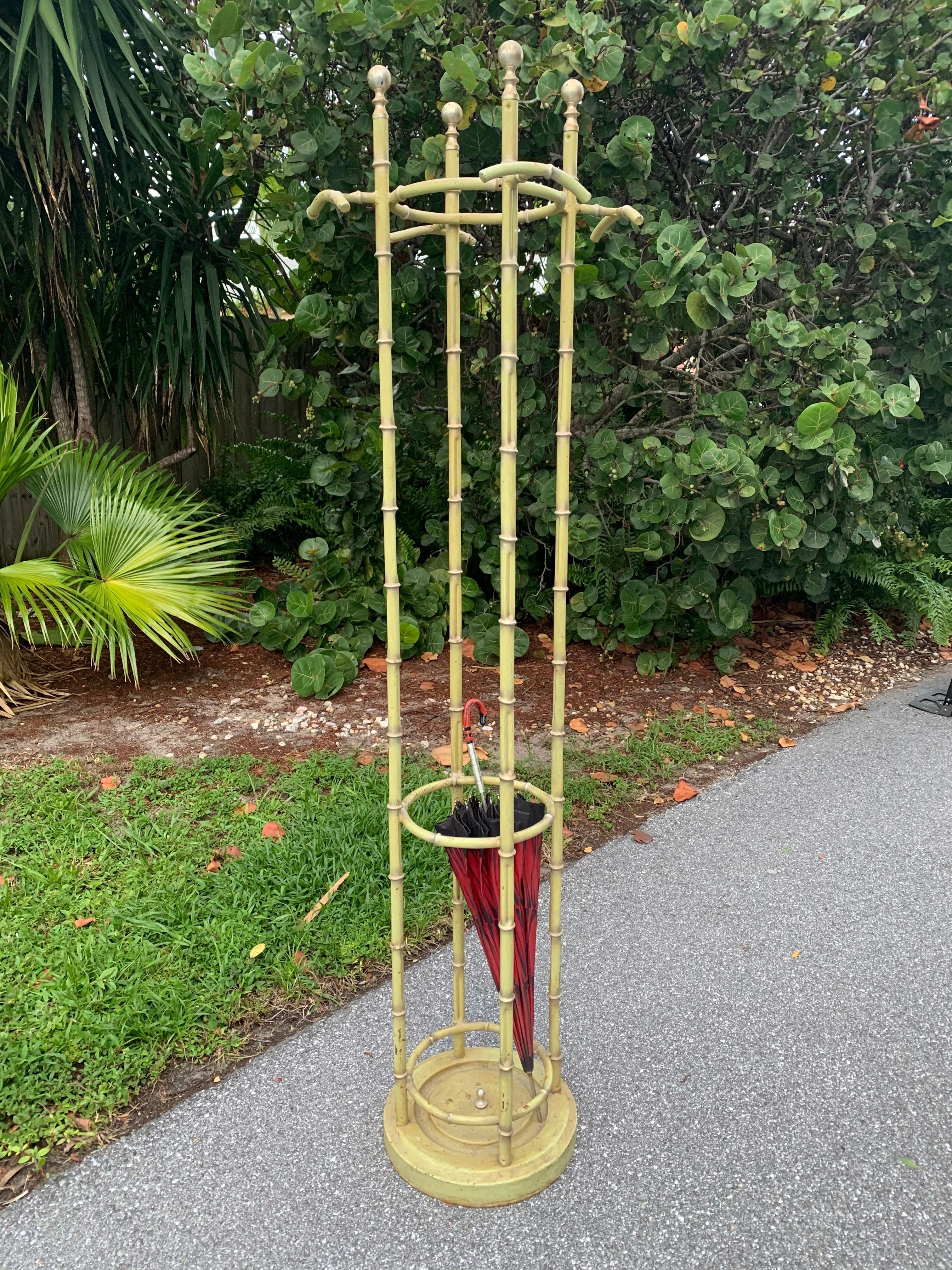 Vintage 1950s faux bamboo metal coat/hat rack with umbrella stand below. Rare piece. This rack has a lot of weight to it with the base being cast iron. Original light green with gold accents. Good vintage condition with some wear to paint and a bit