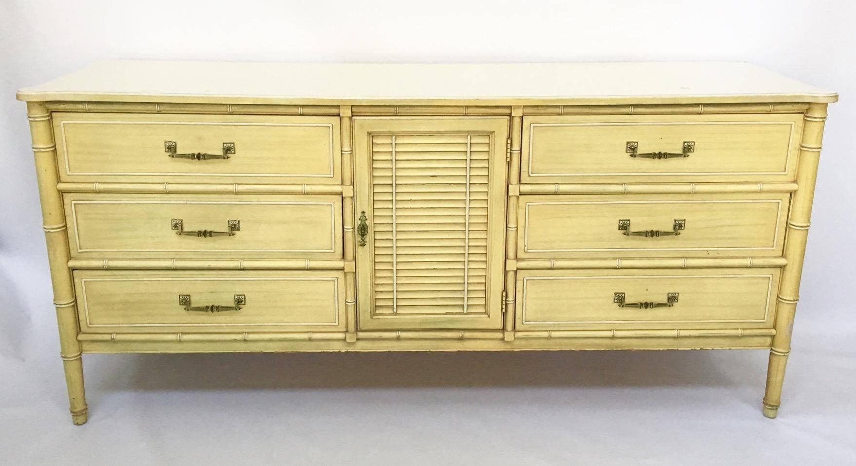 A vintage Bali Hai dresser by Henry Link with faux bamboo accents. Centre door reveals three interior drawers. All original finish. Good as-found vintage condition with some imperfections consistent with age. 

As always, all reasonable offers