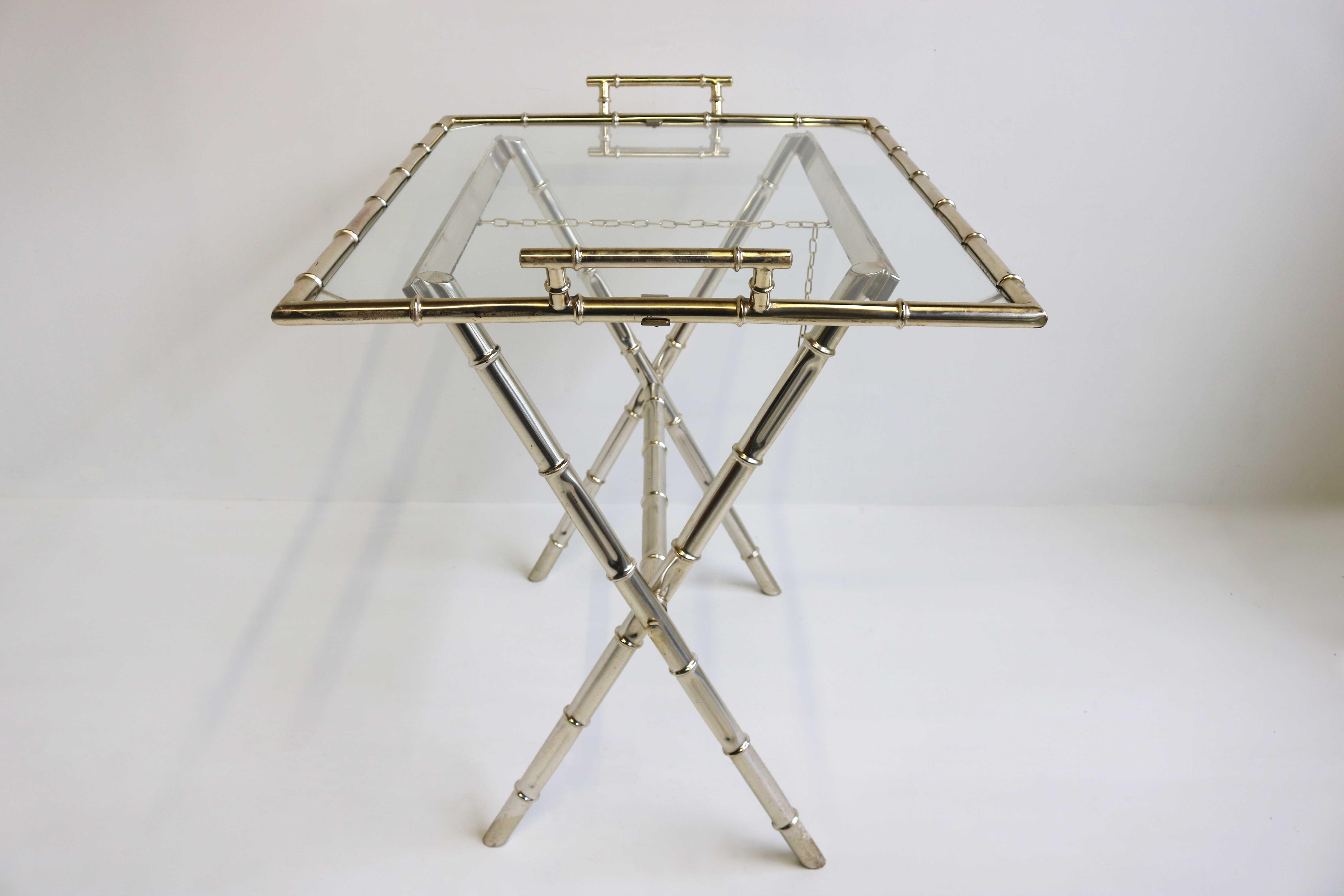 Gorgeous faux bamboo serving stand with glass top by Maison Bagues, France 1960s. 
Height adjustable and foldable stand holding a clear glass serving tray. 
To be used to display and carry cocktails and drinks!
Glass top in good vintage