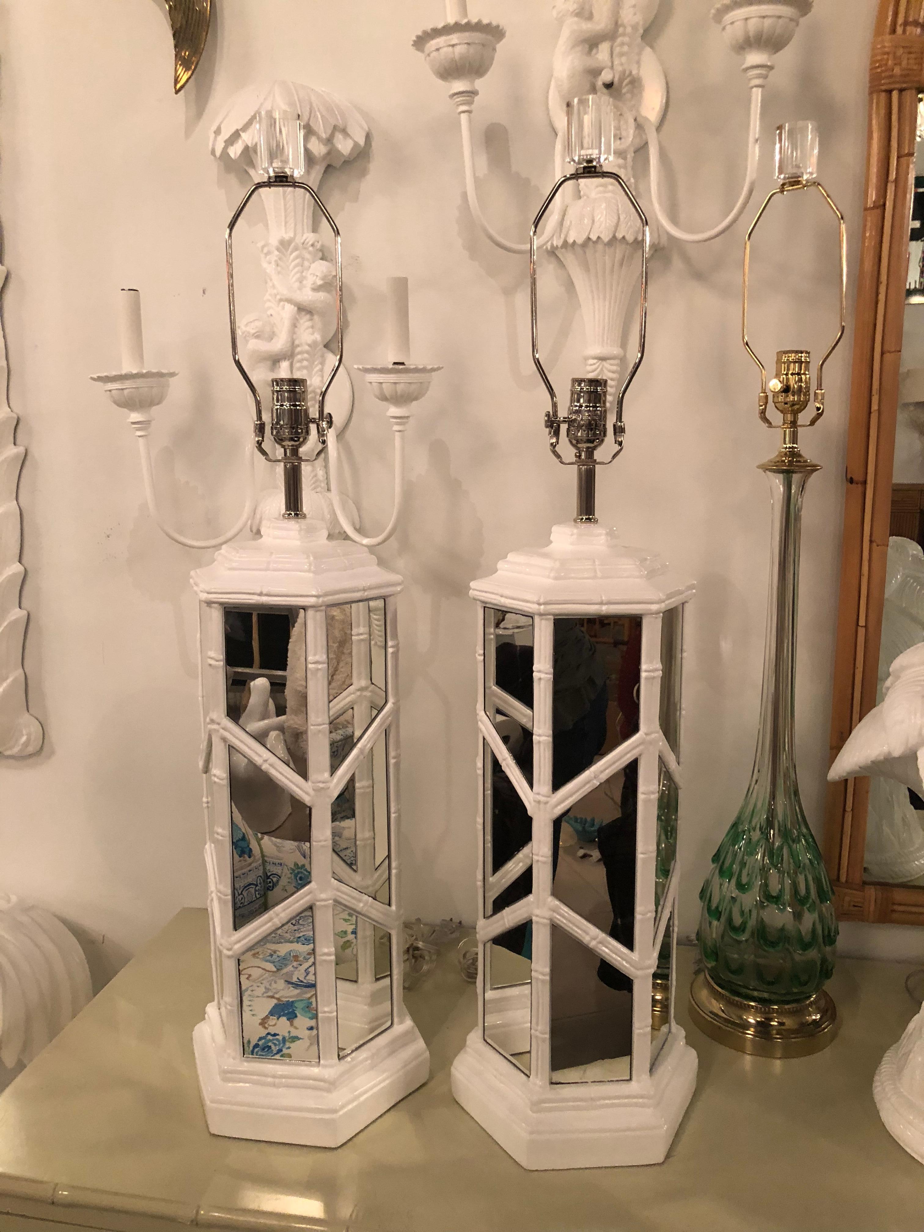 Pair of vintage faux bamboo, Chinese Chippendale, white lacquered mirrored table lamps. Newly wired, new chrome hardware. Original mirror may have some patina. Lucite finials.
Measures: 35 tall to top of finials.