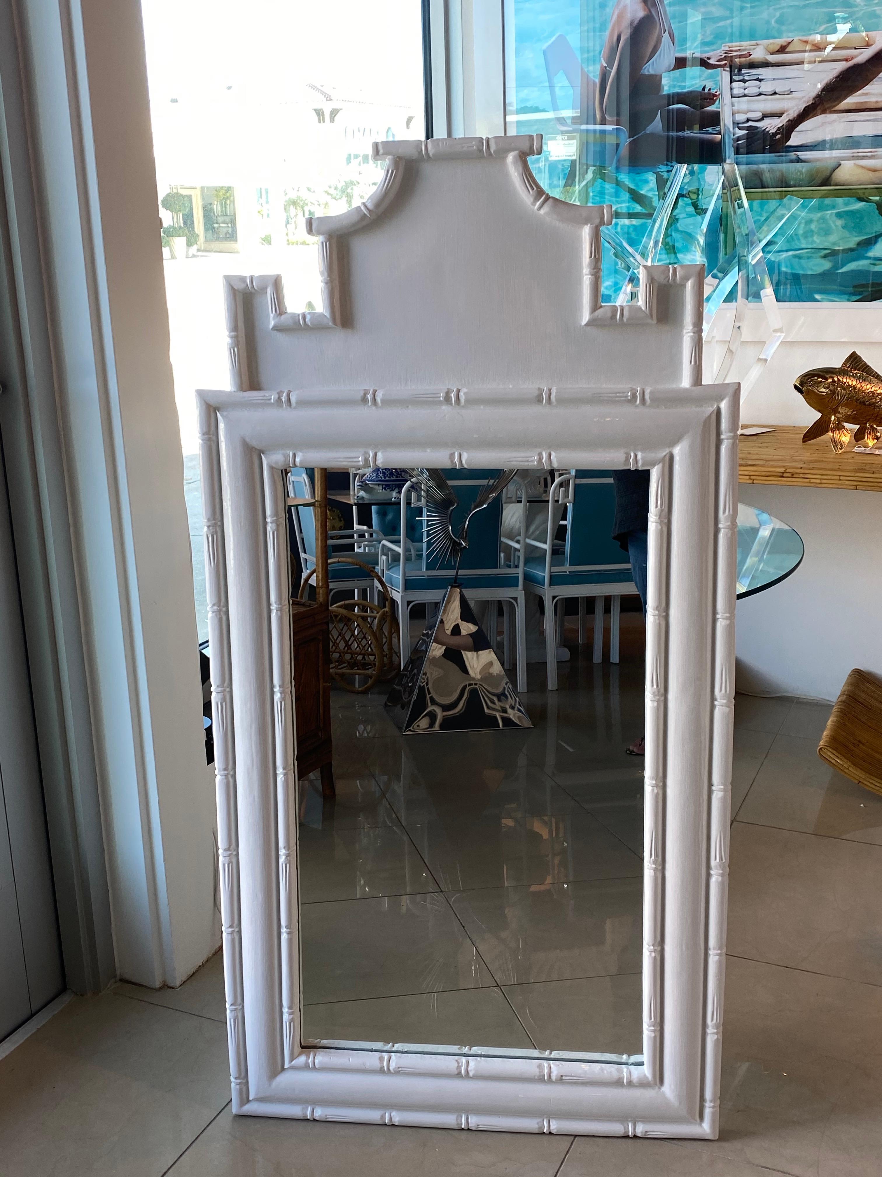 Lovely vintage pagoda faux bamboo chinoiserie wall mirror. New mirror was cut and put inside. Newly lacquered white finish. Lightweight composite mirror.