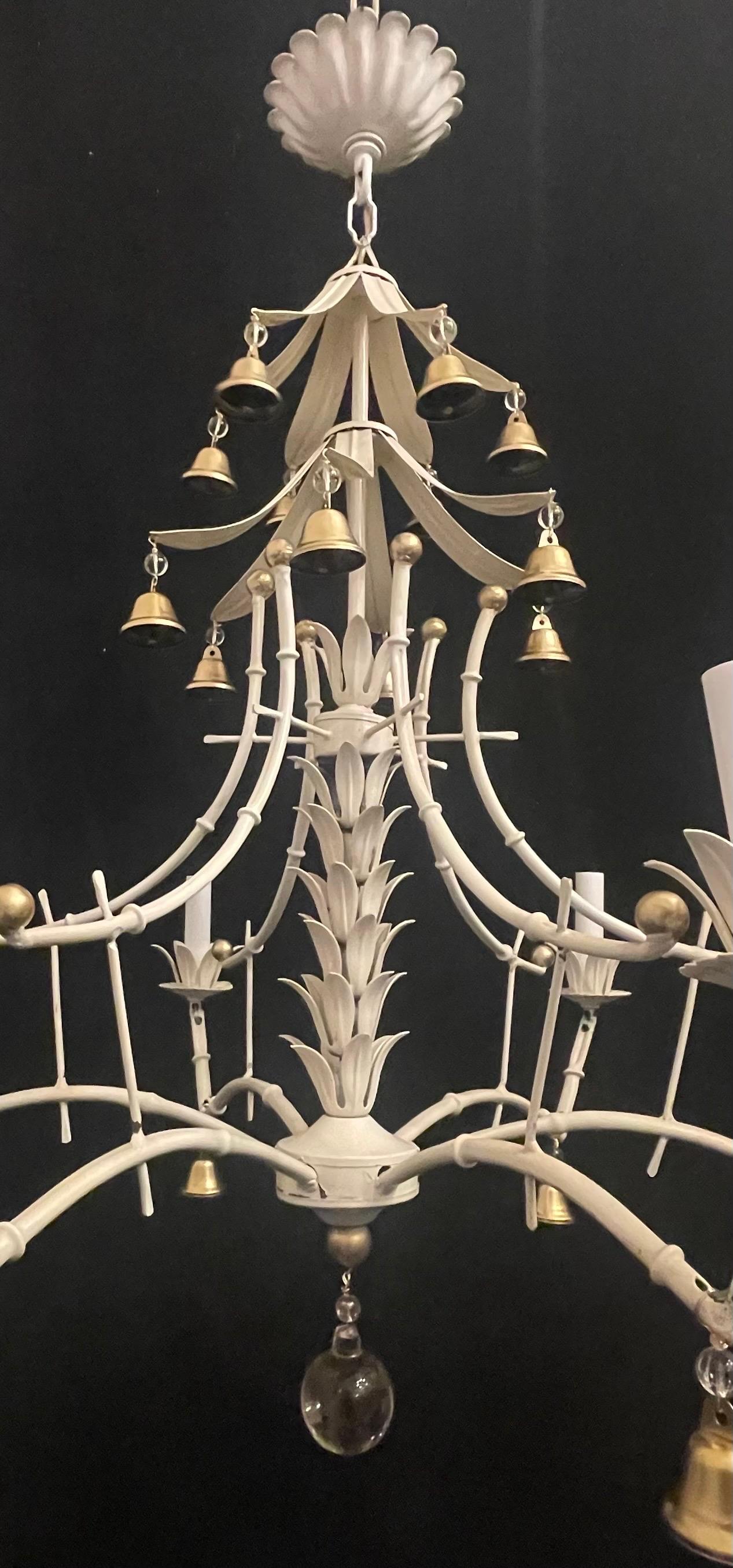 A Wonderful Vintage Faux Bamboo Pagoda Form Tole White With Gold Gilt Highlights Metal Classic Palm Beach Chandelier Having Bell Accents, Completely Rewired With 6 Candelabra Sockets With 40 Watts Per Socket. 
Total Height Listed Includes Chain And