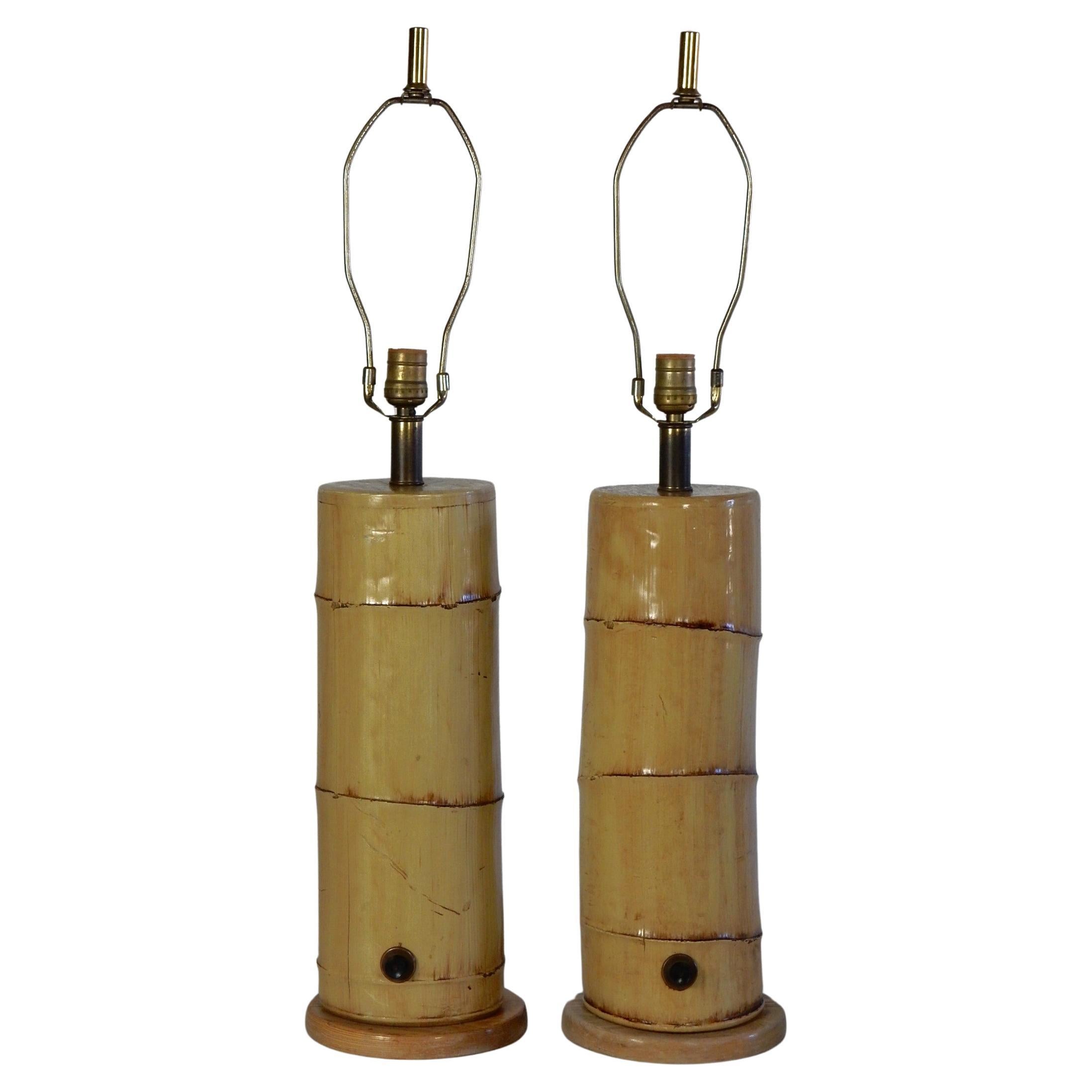 Large heavy pair of vintage 1960's faux bamboo stalk table lamps
from the Moana Hotel in Honolulu Hawaii. We believe they are solid plaster and mounted on an oak wood base. Original on/off switch on the lower portion. They measure 32in to tip of