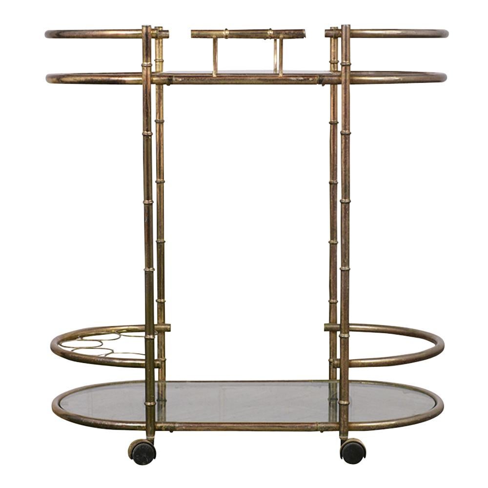 This vintage brass faux bamboo style two tier bar cart is in excellent condition. It features glass inserts with one removable small tray on the top wine rack, bottom shelf, and caster wheels. This bar cart is sturdy, elegant, and ready to be used