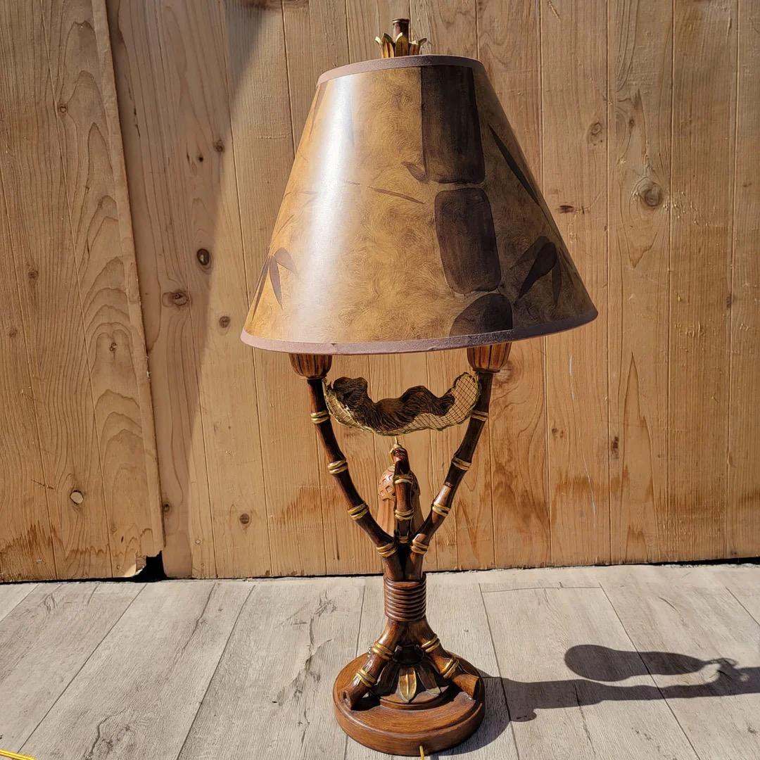 Vintage Tropical Table Lamp with Monkey in Hammock Tiki Light Faux Bamboo with a Tropical Shade by Maitland Smith 

The Vintage Coastal Table Lamp by Maitland Smith features a whimsical design that captures the essence of tropical relaxation.